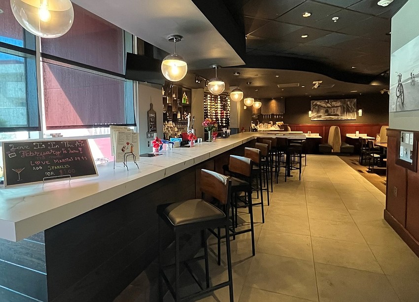 The renovations at the Melting Pot Sarasota include an upgraded bar area with nearby peninsula tables.