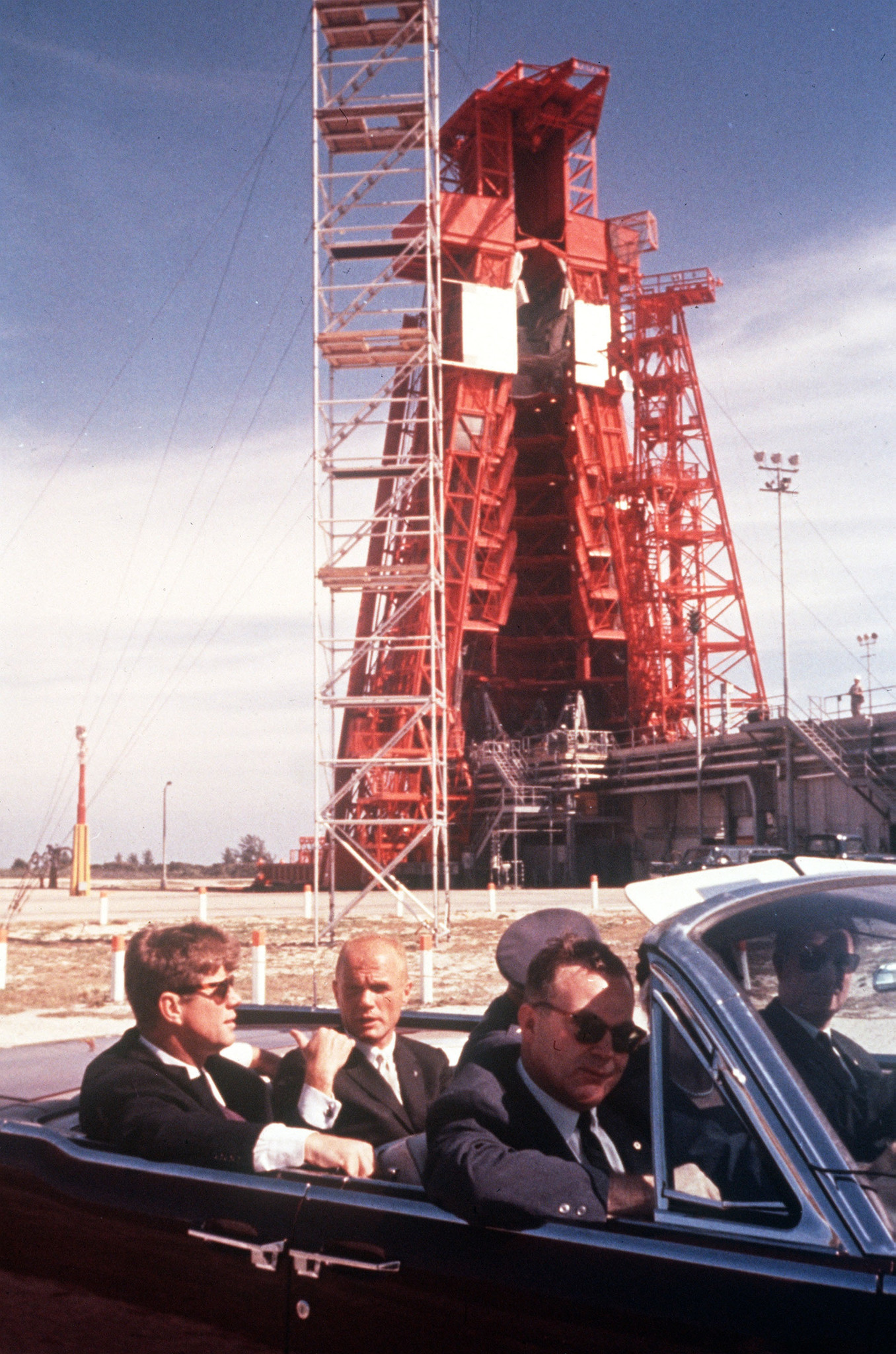 Astronaut John Glenn rides in the back seat of an...