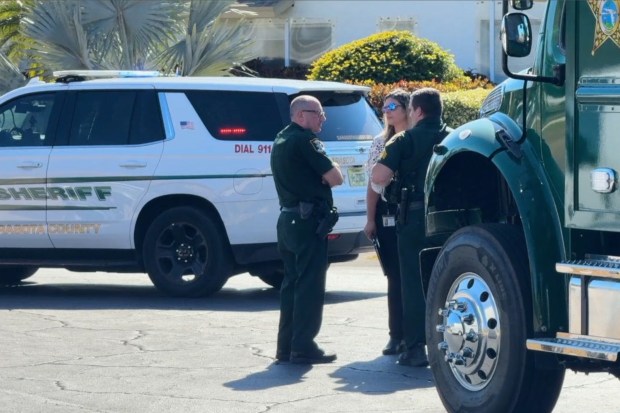 In this image taken from video provided by WFTS, law enforcement officers investigate a scene, Wednesday, Feb. 11, 2026, in Sarasota, Fla., which authorities say is connected to another crime scene, in Fort Lauderdale, Fla. (WFTS via AP)