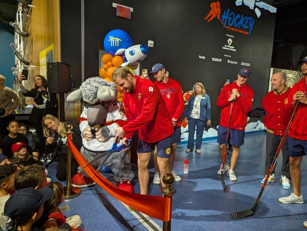 Florida Panthers captain Aleksander Barkov cuts the ribbon on the new hockey exhibit at the Museum of Discovery and Science. (Audra Pankrez/Courtesy)
