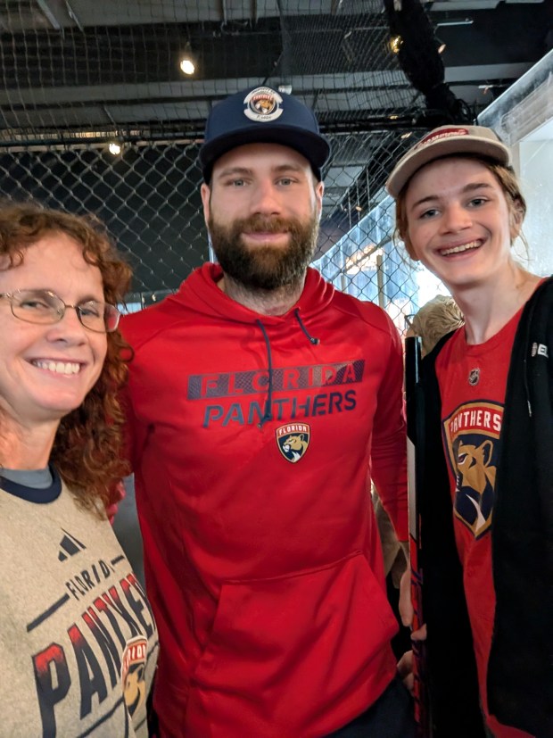 Audra and Evan Pankrez met Florida Panthers player Jonah Gadjovich, center, at the opening of the new hockey exhibit at the Museum of Discovery and Science. (Audra Pankrez/Courtesy)