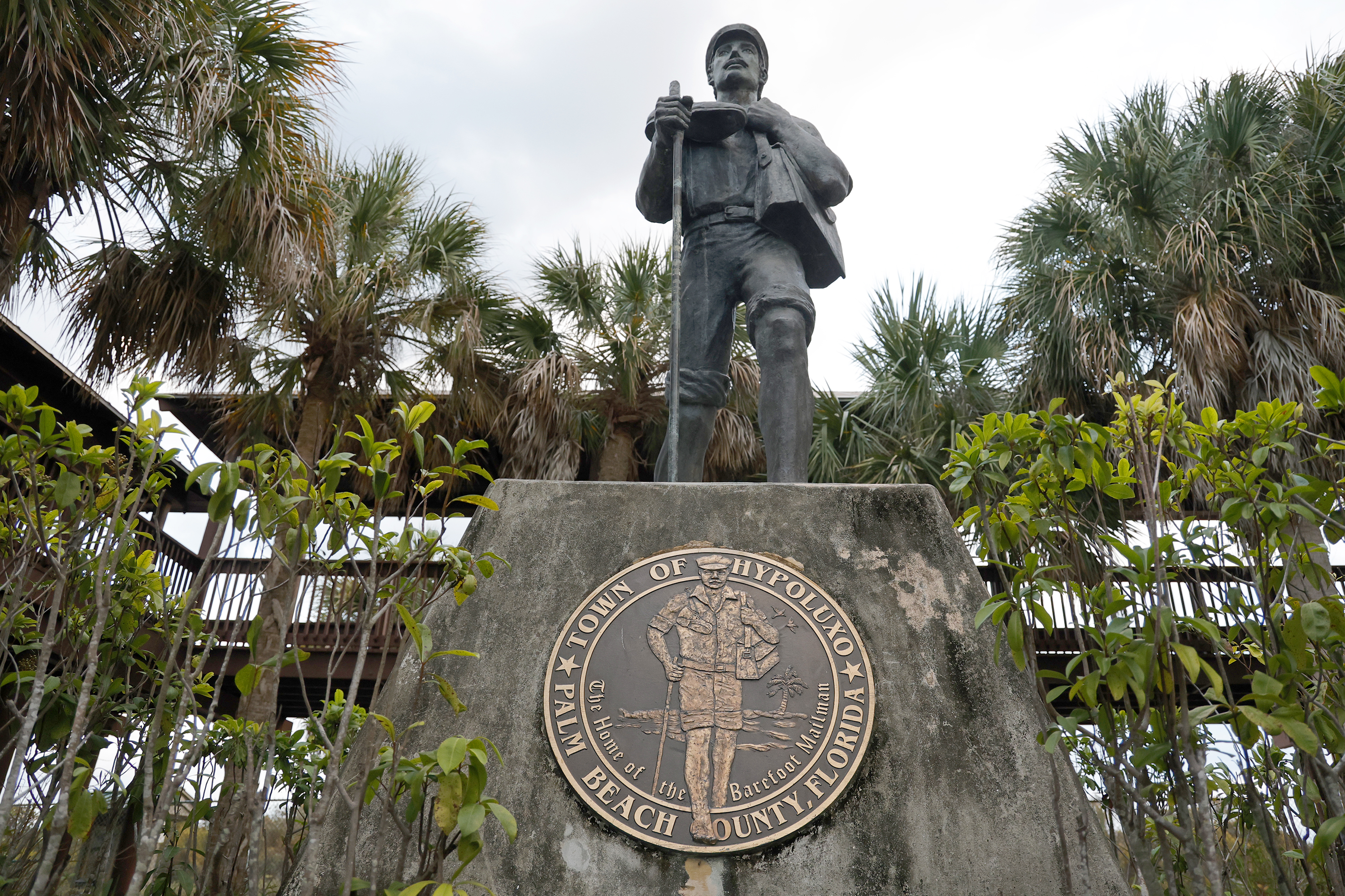 A statue of the Barefoot Mailman greets guests at the...