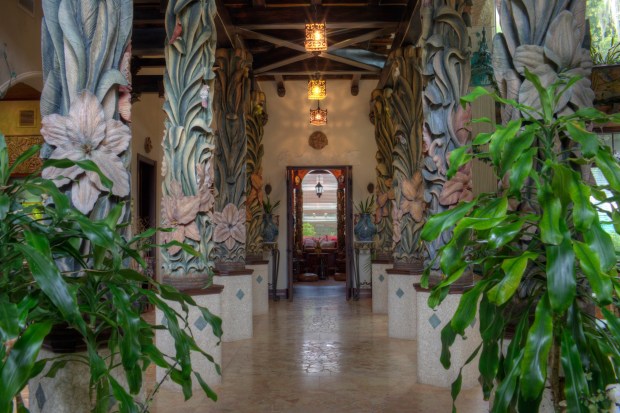 Massive wooden columns and interior doors are hand-carved and painted works of art. (Courtesy of Saunders Real Estate)