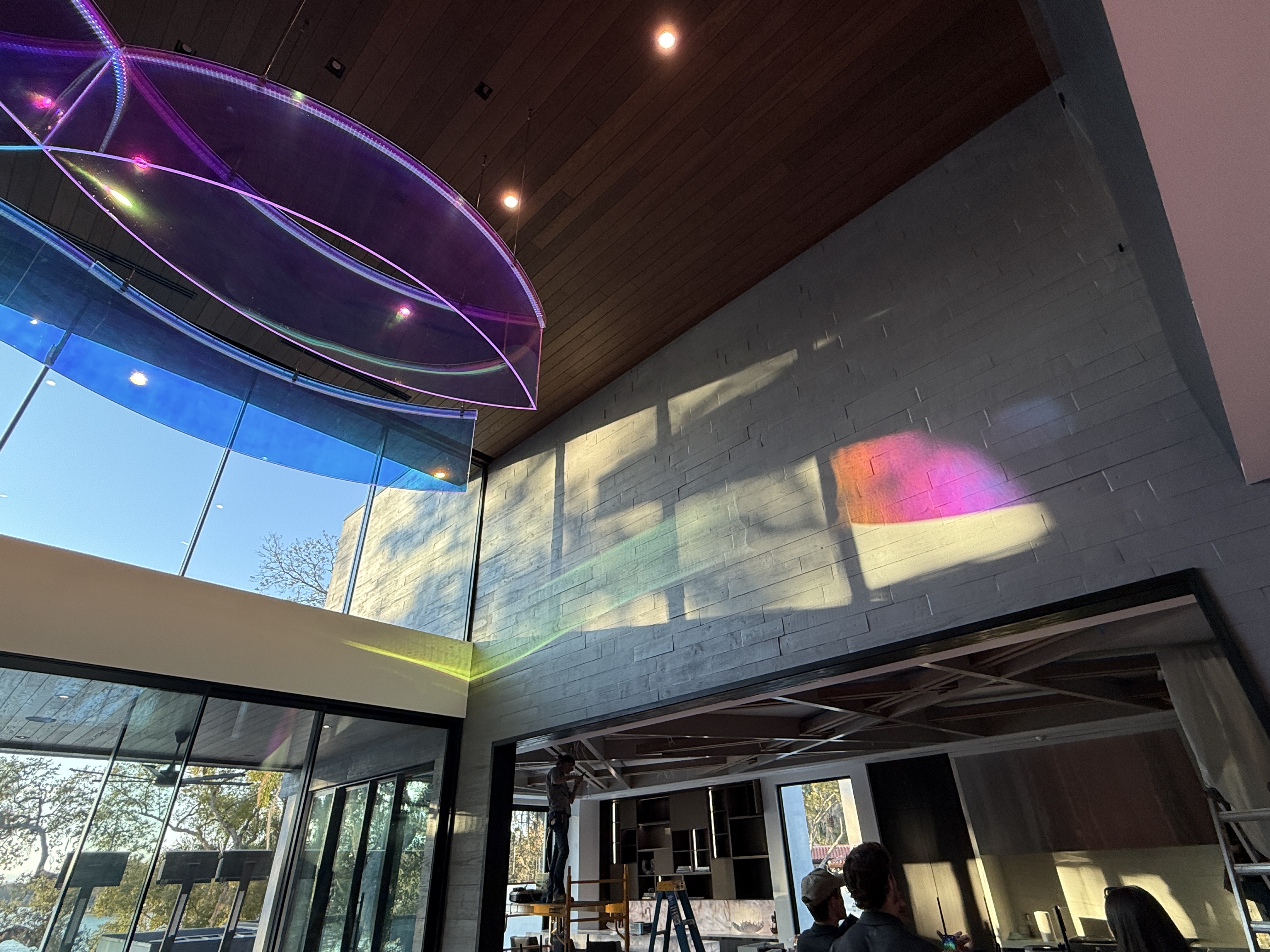 The acrylic chandelier creates a rainbow effect by refracting the...