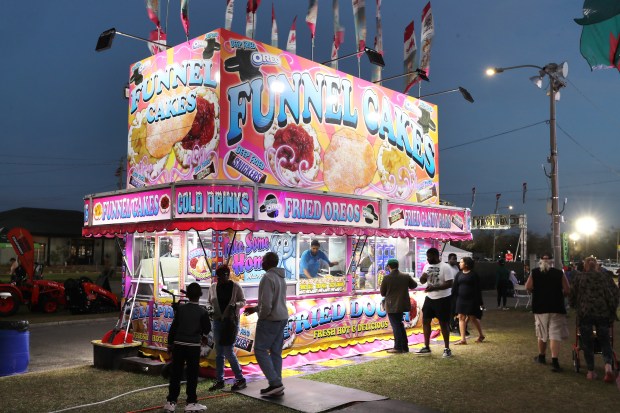 Funnel Cakes are served at a stand during the Central Florida Fair at the fairgrounds in Orlando on Tuesday, March 4, 2025. The Central Florida Fair, in its 113th year, features a midway with rides, games, food, live music and entertainment, livestock exhibits and more. (Stephen M. Dowell/Orlando Sentinel)