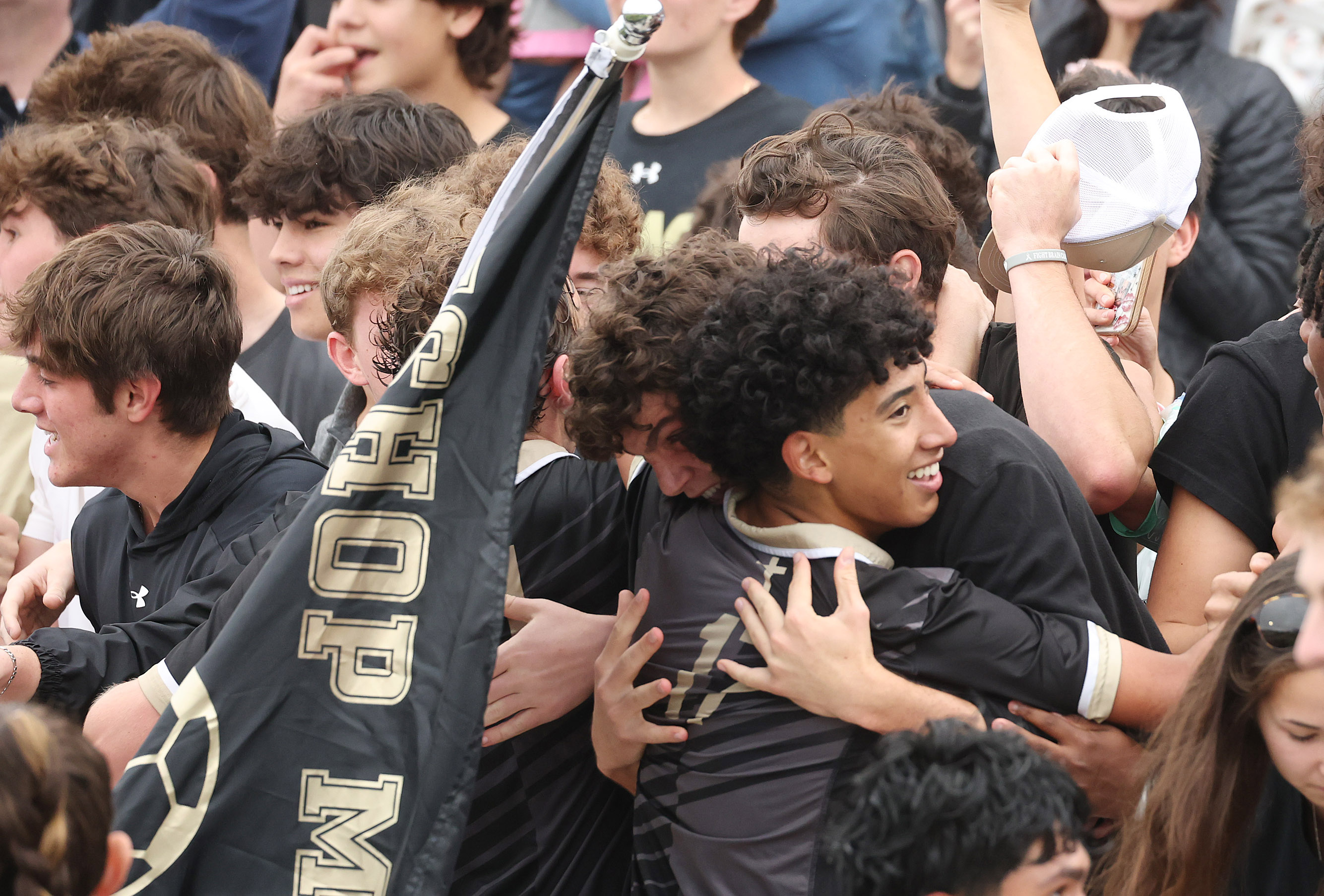 Bishop Moore Catholic High School soccer players celebrate with students...