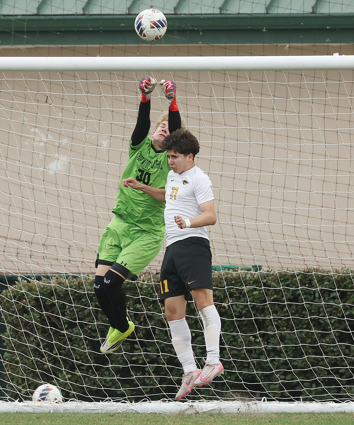 Bishop Moore Catholic High School goalkeeper Colin Norton (30) leaps...