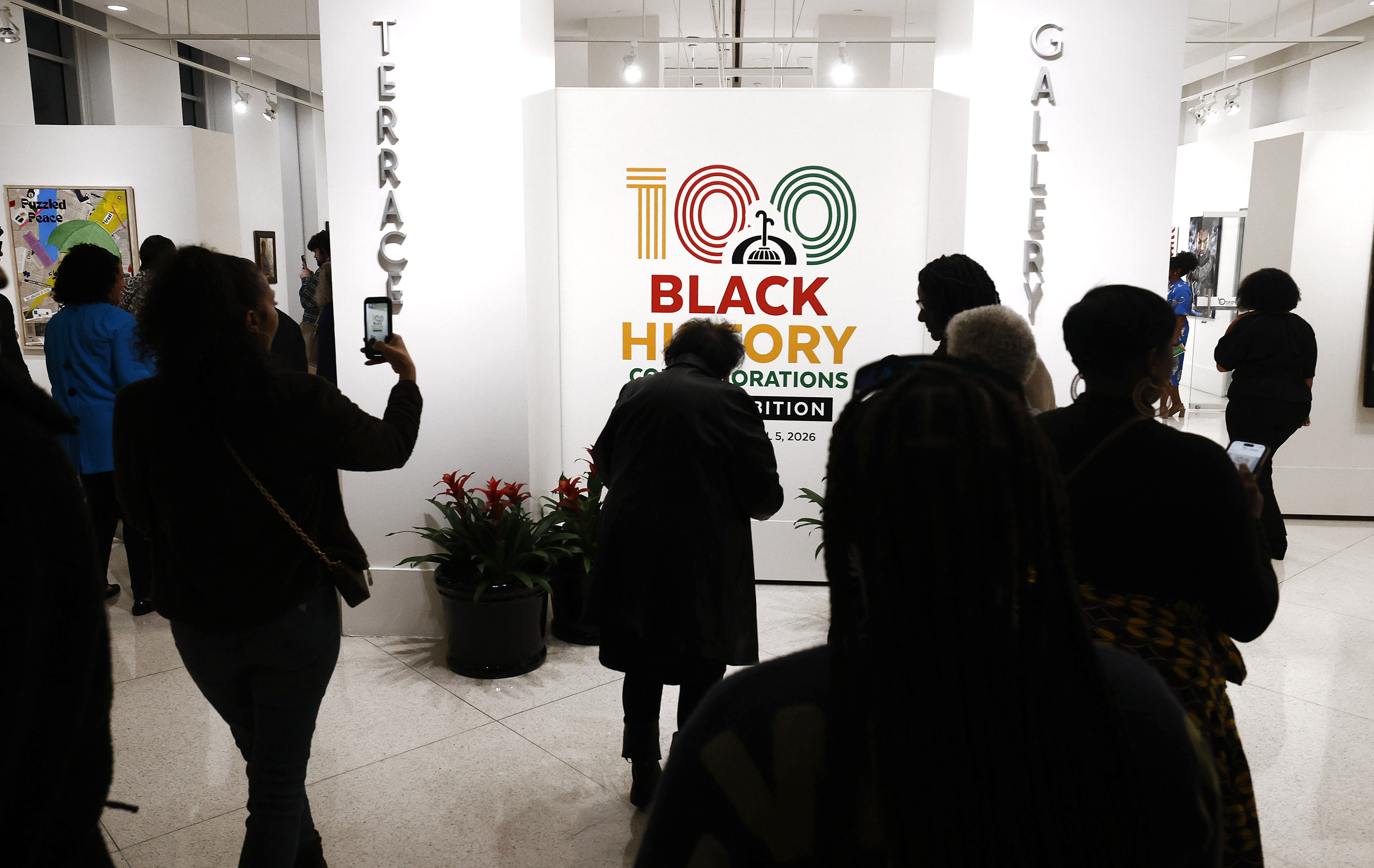 Visitors rush in to view art on display during the...