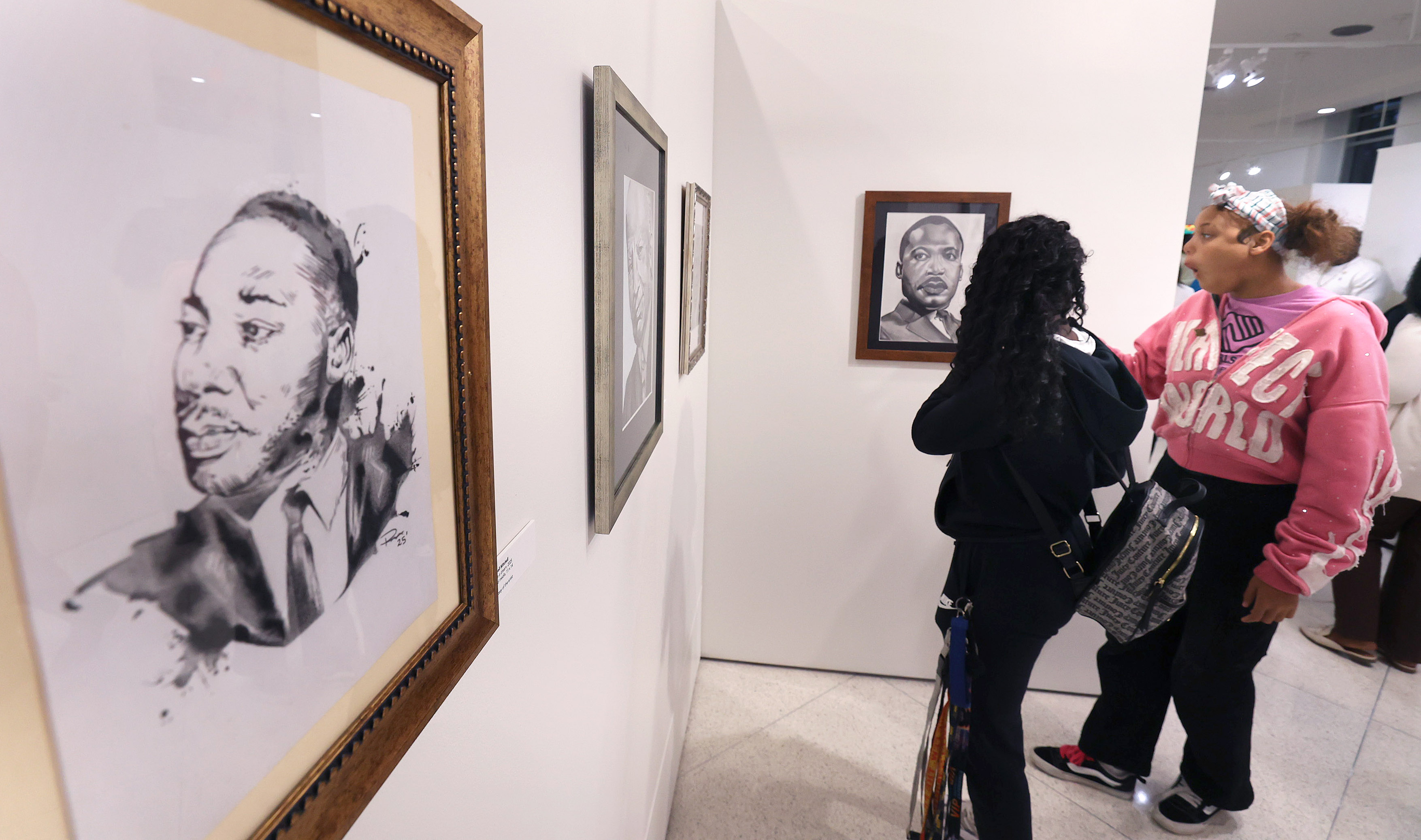 Visitors view art on display during the Opening Reception of...