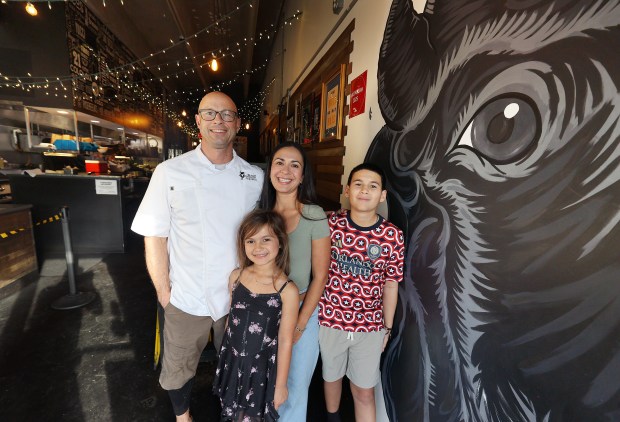 Restaurant kids Ryder and Lilly Calloway with their parents, John and Juliana, celebrate 10 years of tacos in Mills 50 at Black Rooster Taqueria. (Stephen M. Dowell/Orlando Sentinel)