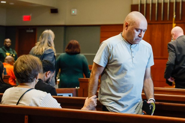 Angel Hernandez receives a comforting hand from a loved one after he returns from making an emotional statement to Judge Keith Carsten during the sentencing hearing for Richard Ferguson, who was convicted of manslaughter after letting his 15-year-old son drive his car, leading to a crash that killed Hernandez's wife and grandchildren. (Rich Pope/Orlando Sentinel)