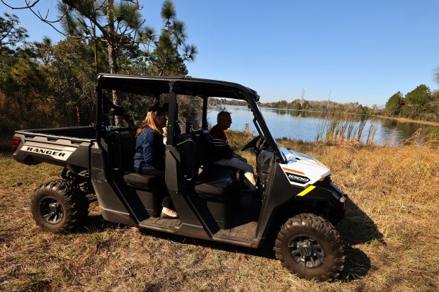 Tim and Marie Kuck are pictured on Thursday, January 29, 2026, on a 400 acre tract of land in Orlando where they plan to build a community for disabled people. (Stephen M. Dowell/Orlando Sentinel)