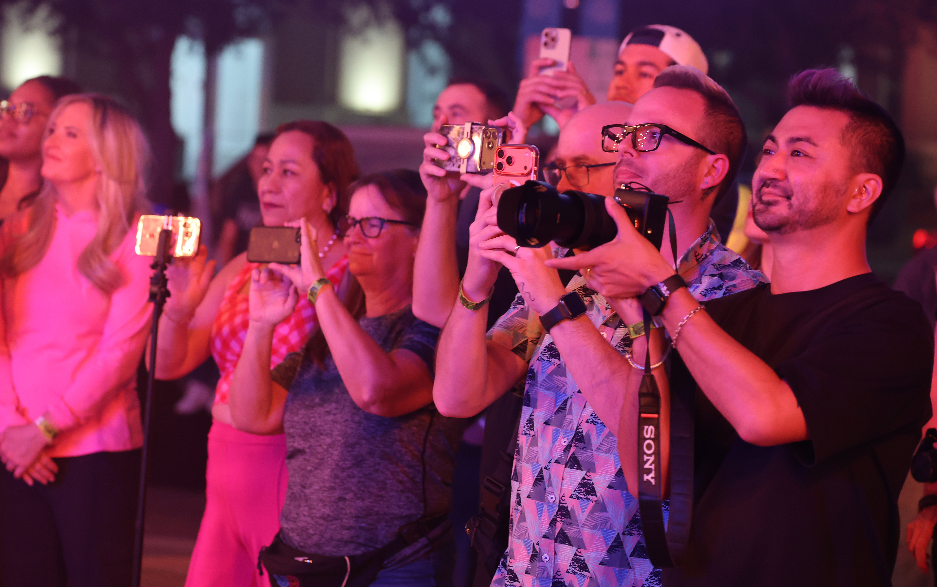 Attendees take pictures during a tech rehearsal media preview of...
