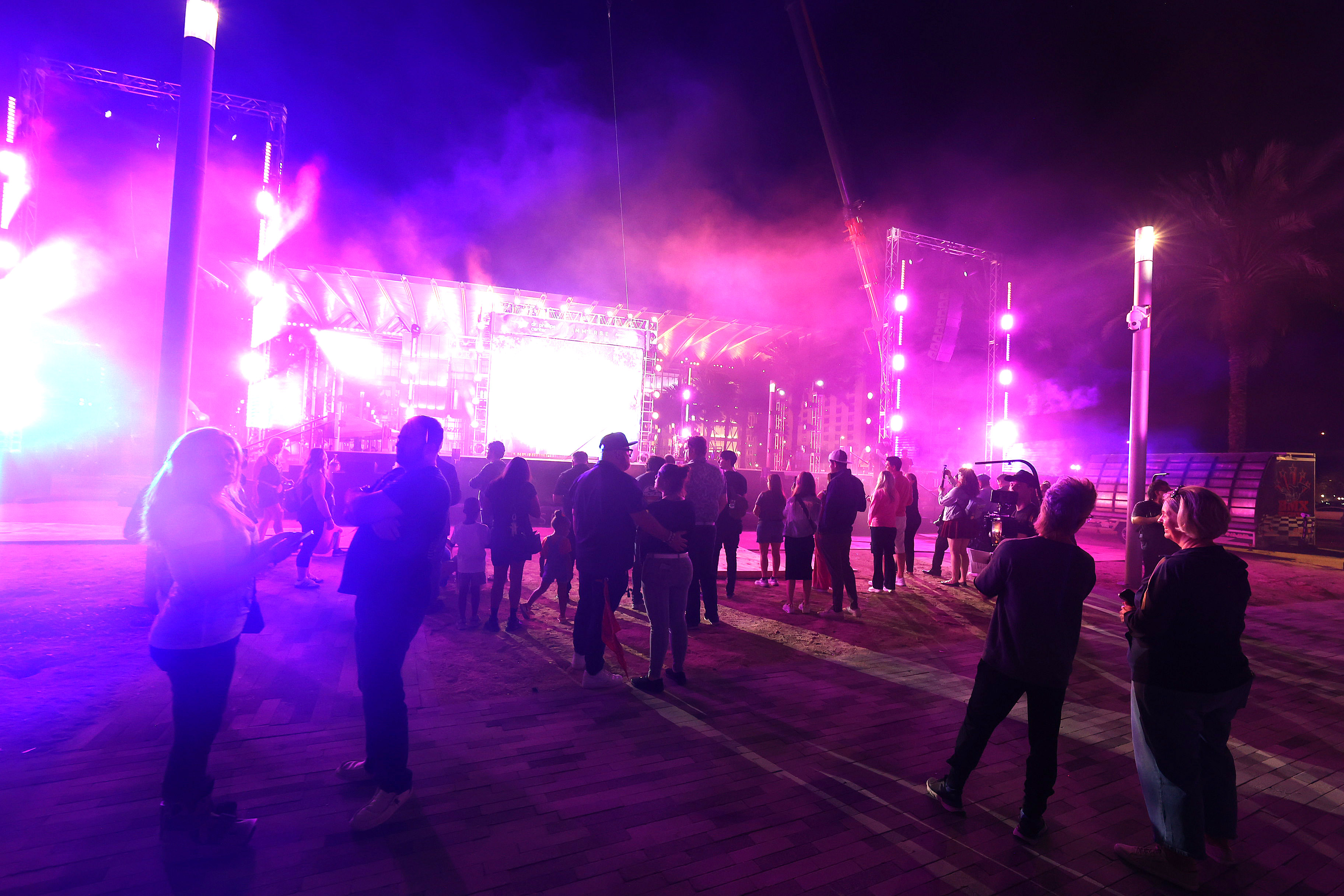 A crowd gathers for a performance during a tech rehearsal...