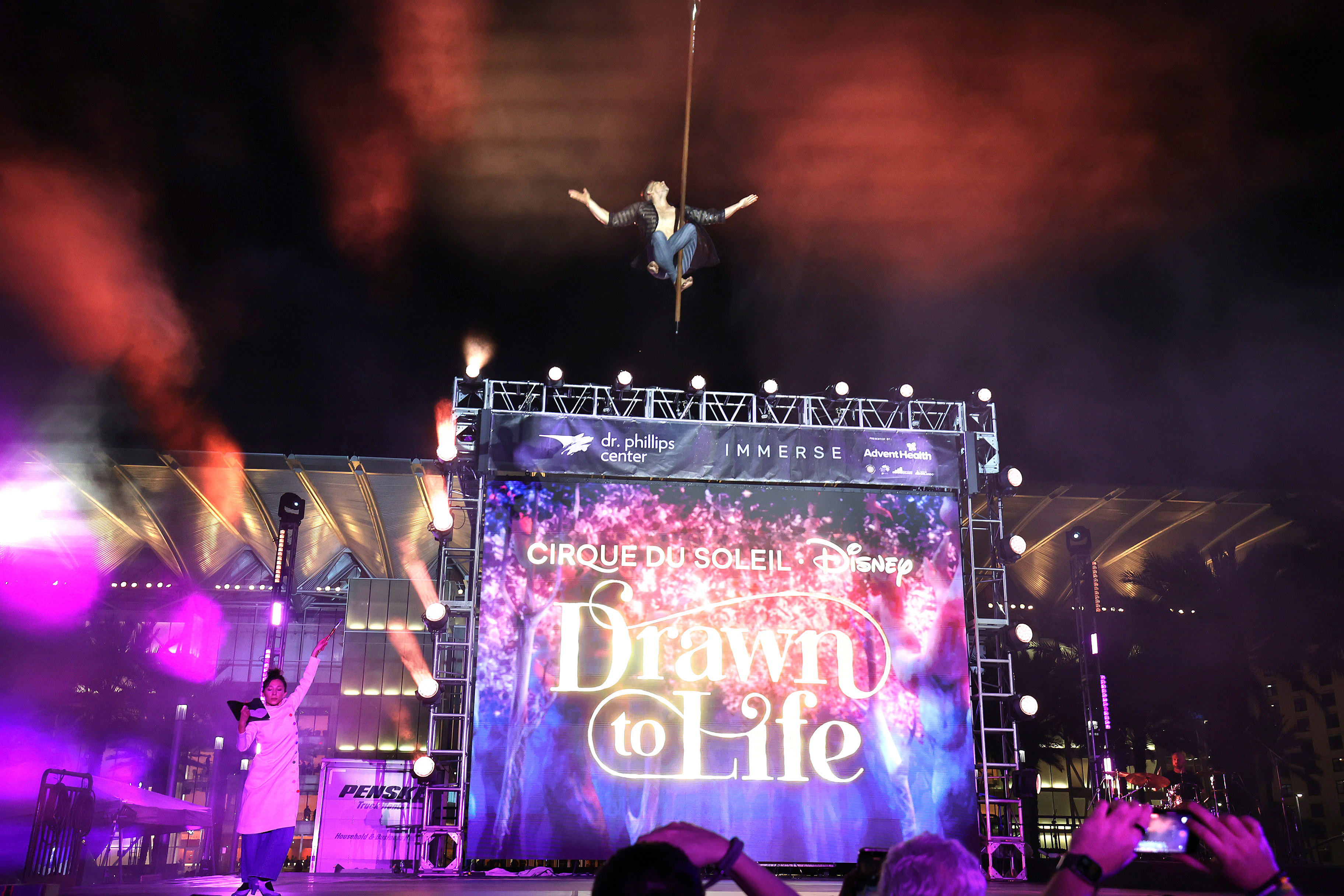 A Cirque du Soleil performer soars as he performs during...