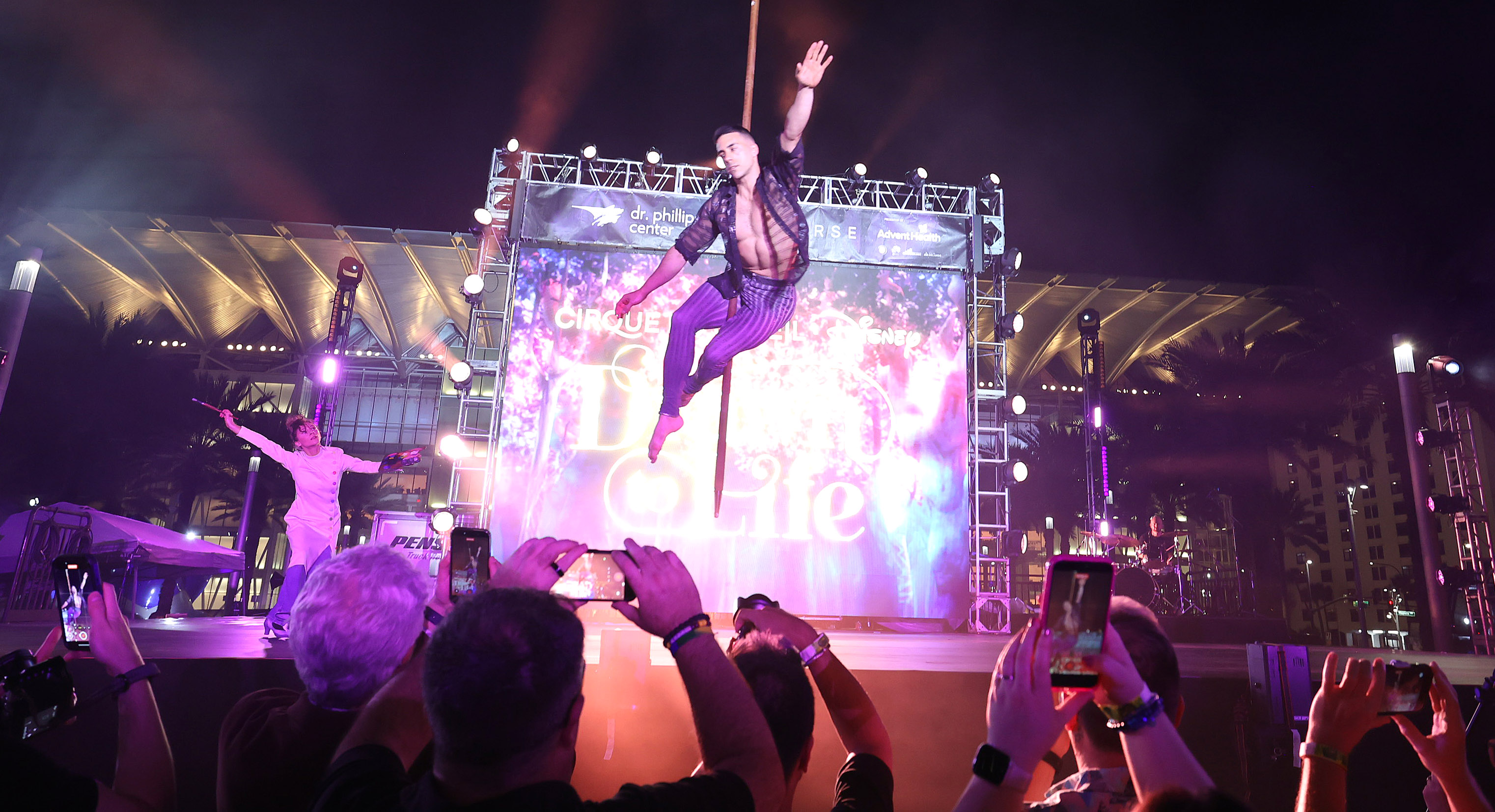 A Cirque du Soleil performer soars as he performs during...