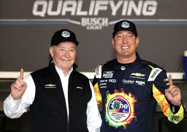 NASCAR driver Kyle Busch, right, and Hall of Famer team owner, Richard Childress pose for photos after winning the pole during Daytona 500 qualifying Feb. 11 at Daytona International Speedway. (James Gilbert/Getty Images)