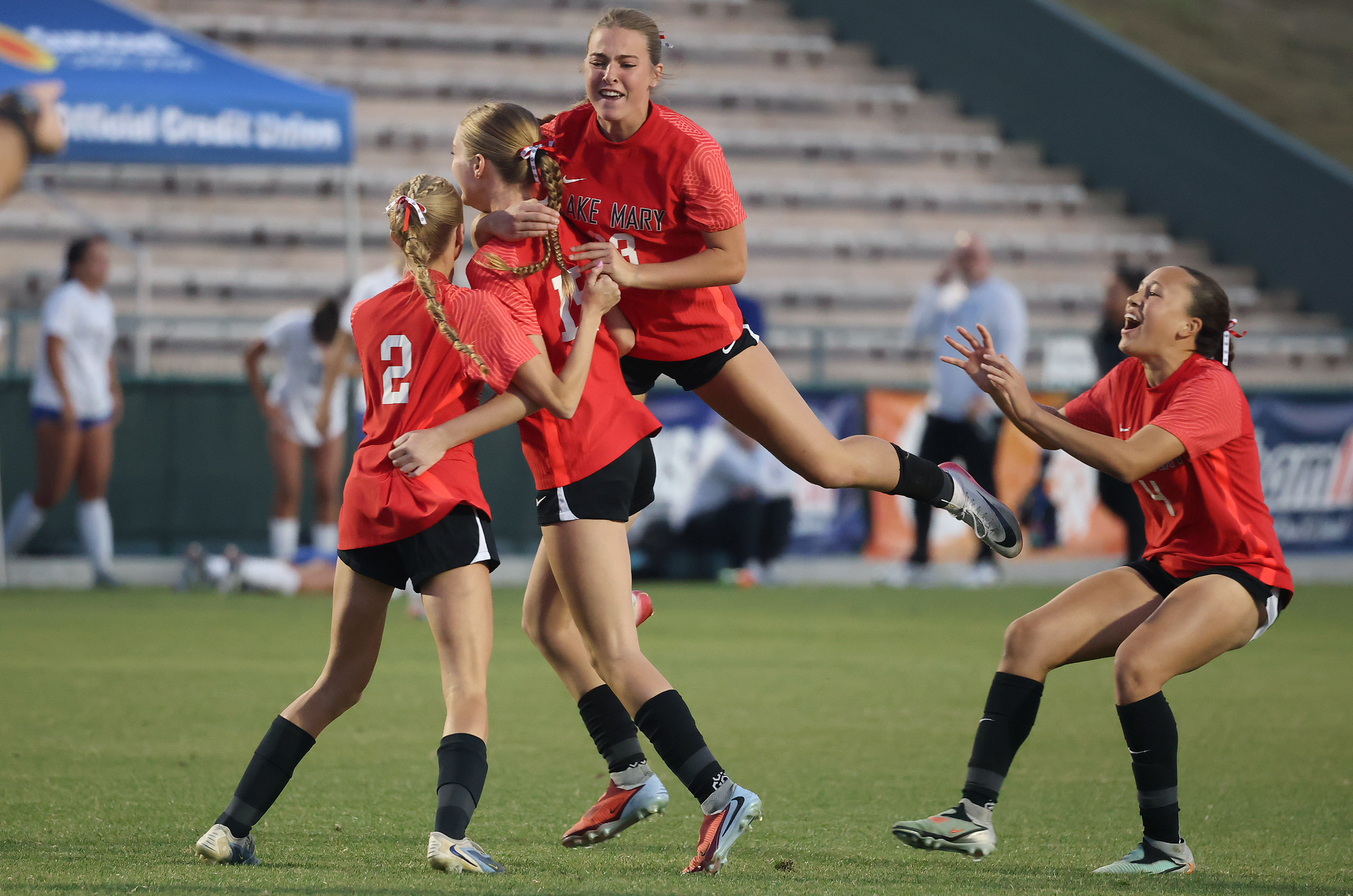 Lake Mary High girls soccer players celebrate after winning the...