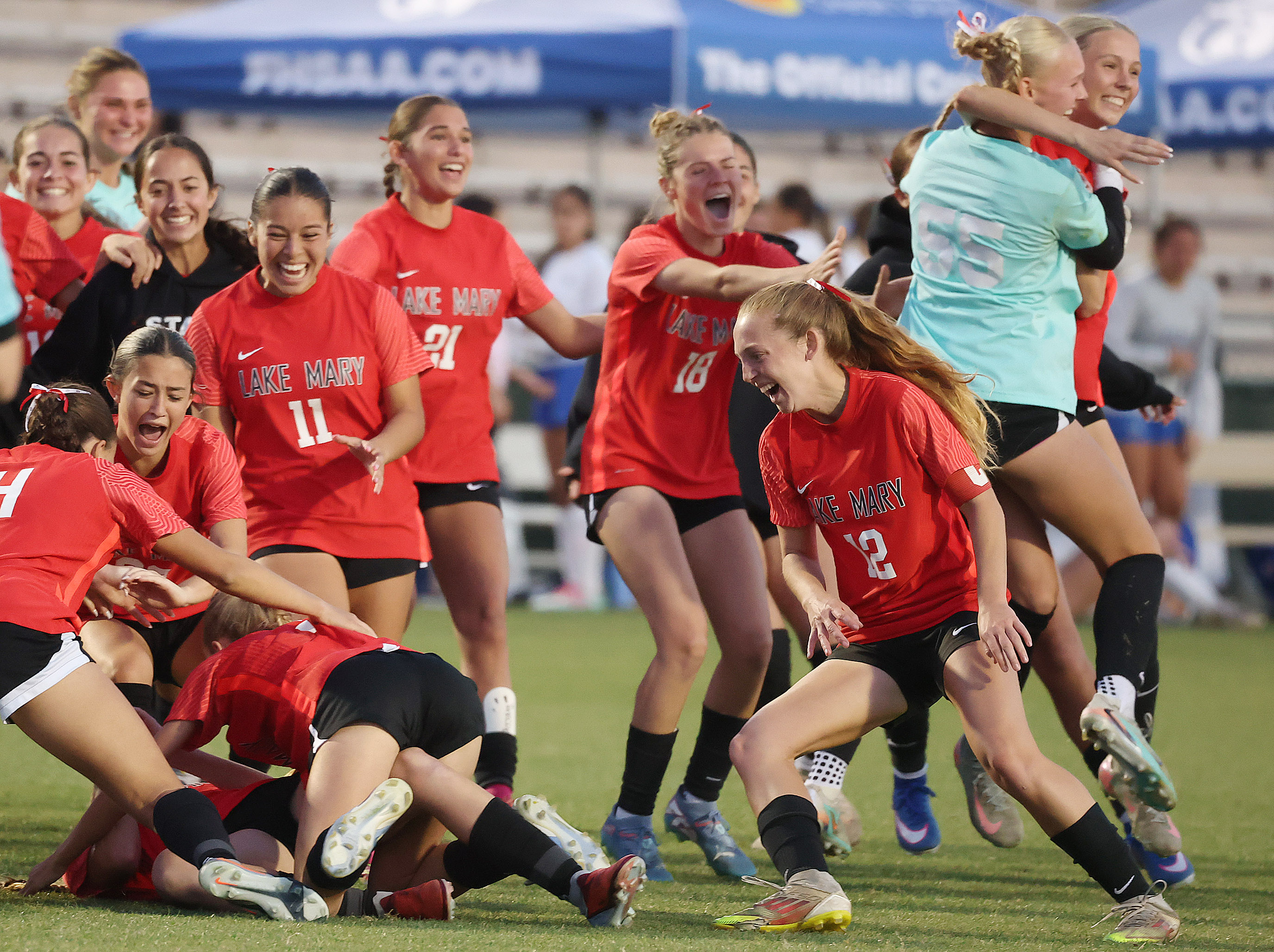 Lake Mary High girls soccer players celebrate after winning the...