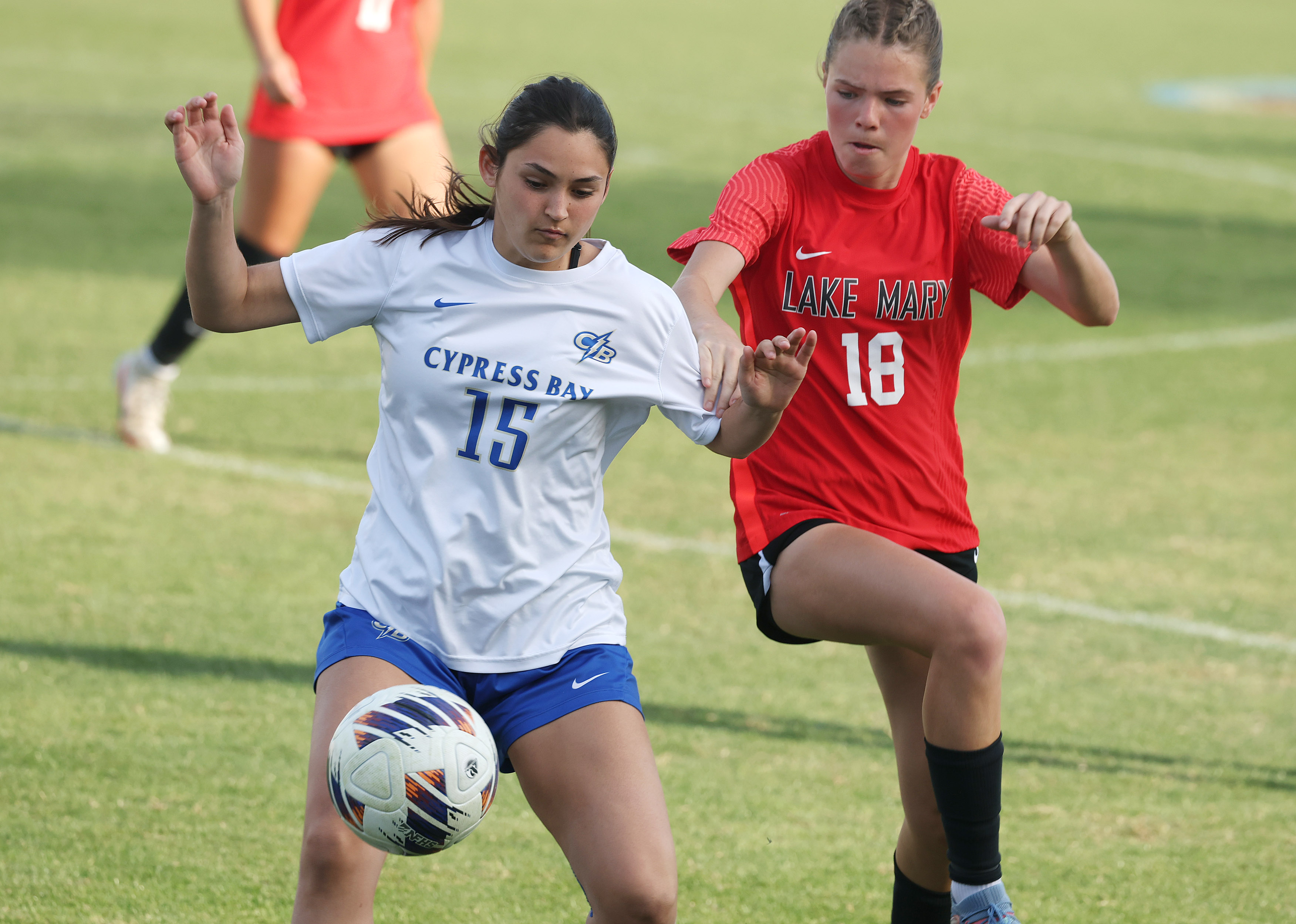 Lake Mary High player Teagan Jahns (18) and Cypress Bay...