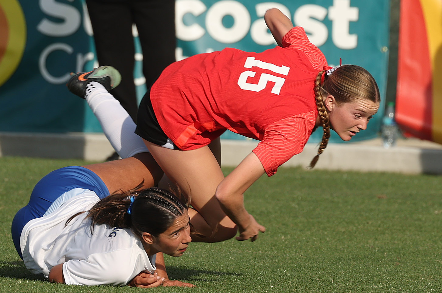 Lake Mary High player Kailey Susi (15) runs over a...