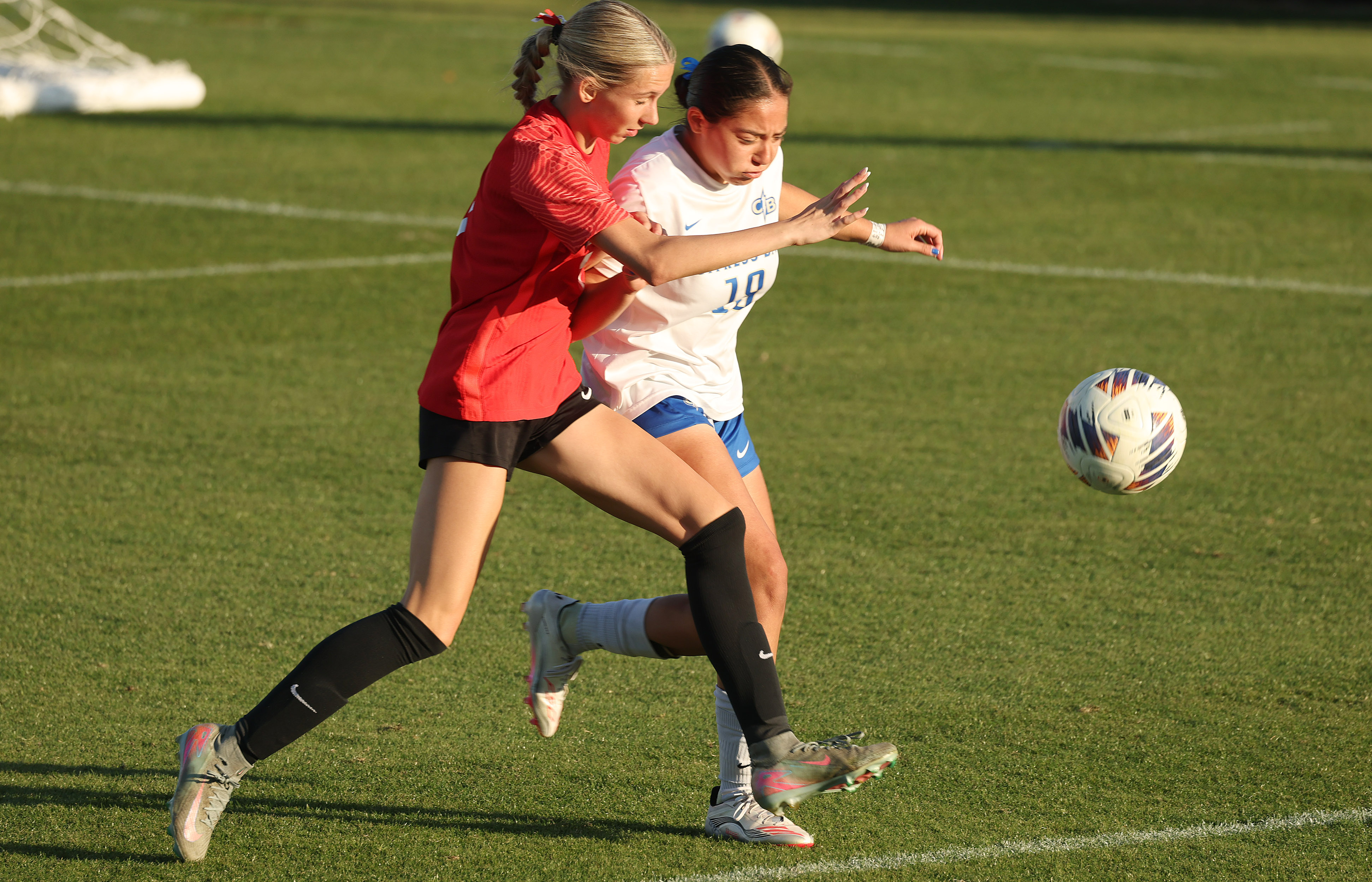 Lake Mary High player Siena Sigurdsson (left) chases the ball...