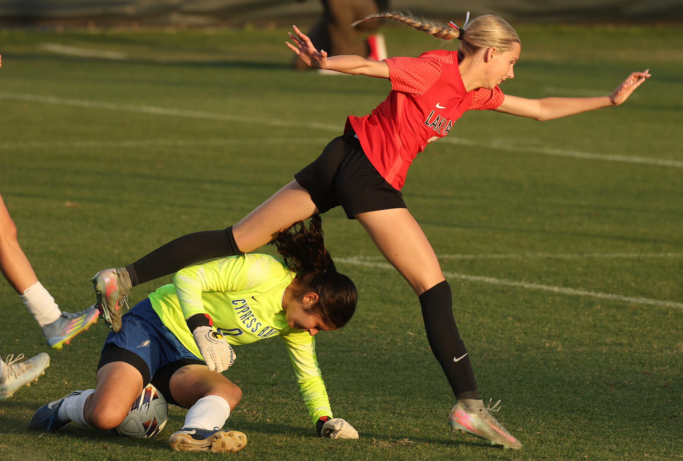 Lake Mary High player Siena Sigurdsson (7) leaps over Cyrpess...