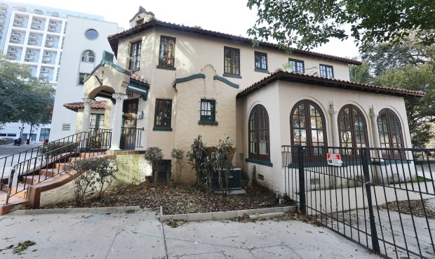 The Lubbe House, at the edge of Lake Eola Park, is pictured on Tuesday, February 10, 2026. The house might be demolished as part of a plan to build a gateway into Lake Eola. Community members are trying to get the house a landmark designation to prevent it from being torn down. (Stephen M. Dowell/Orlando Sentinel)
