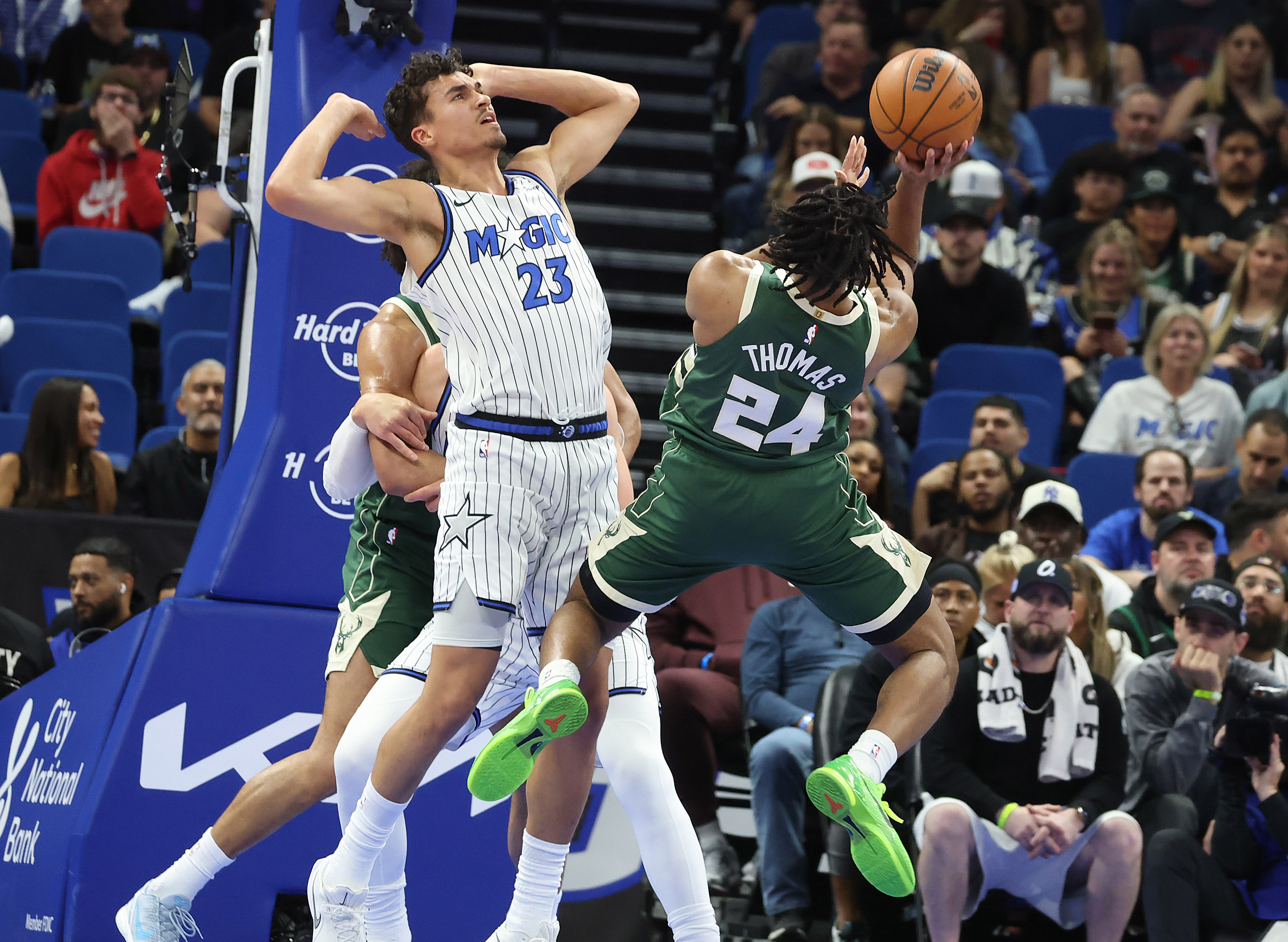 Milwaukee guard Cam Thomas (24) shoots beside Orlando forward Tristan...