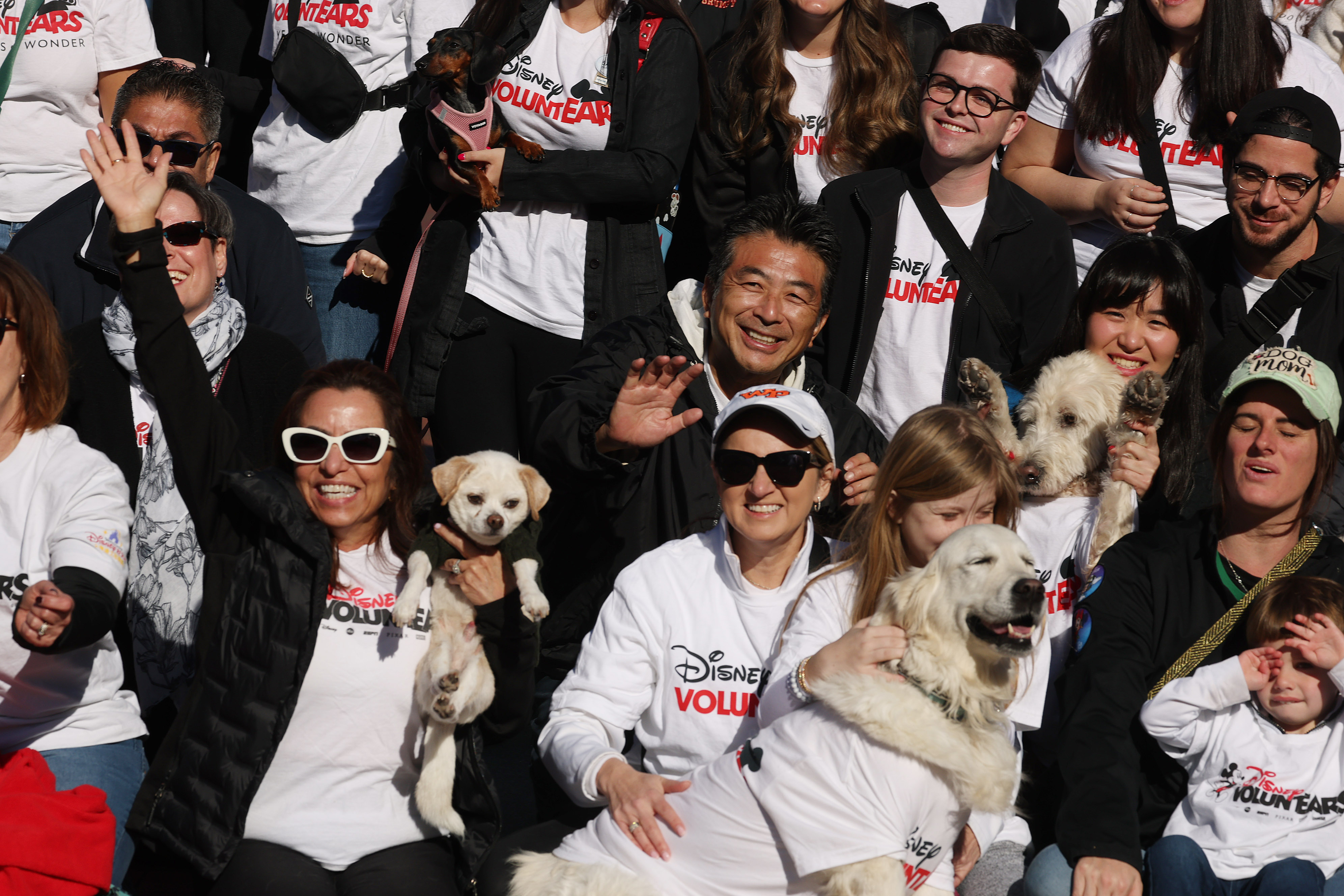 Dog lovers pose for a picture during the Paws in...