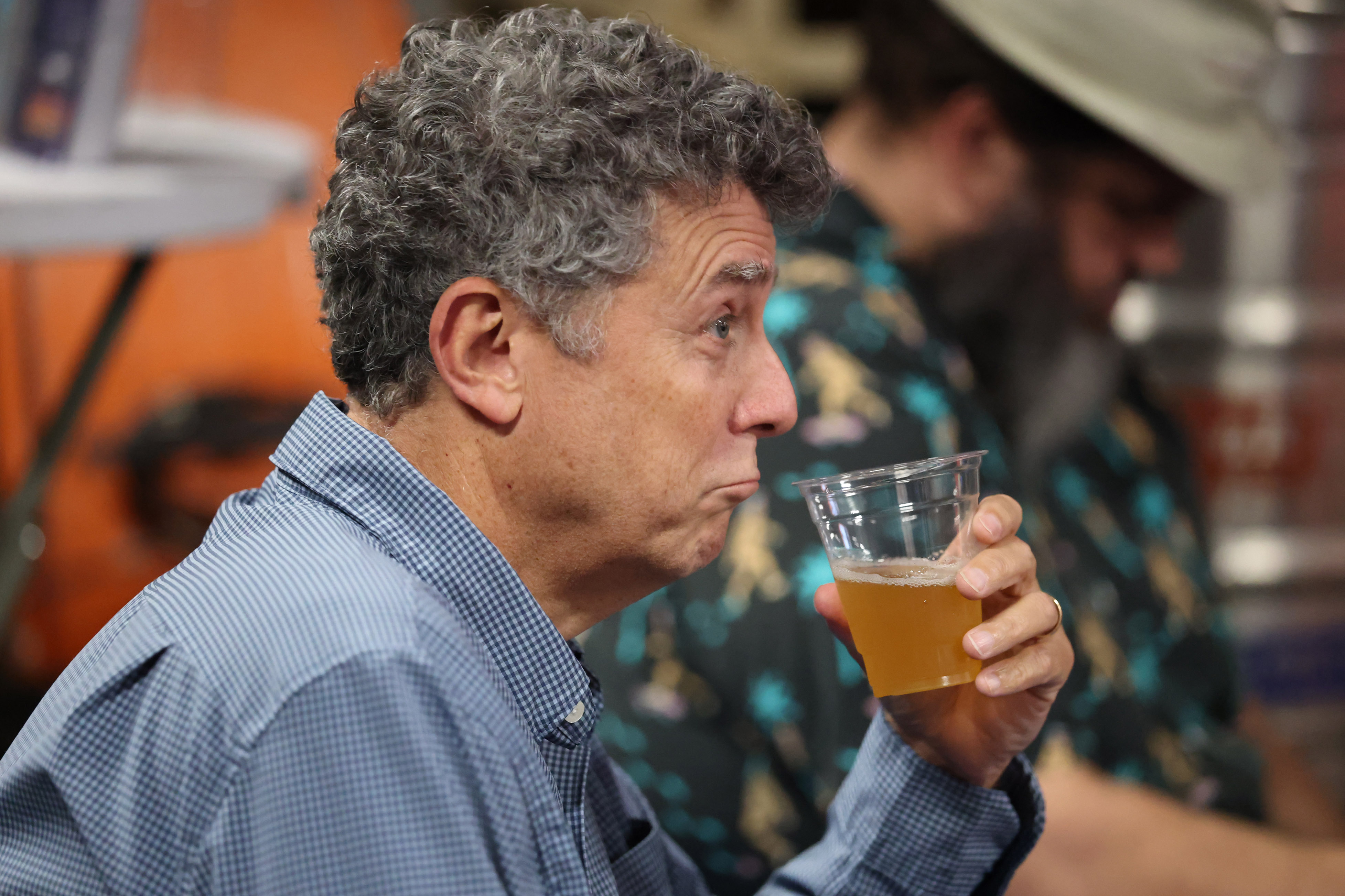 Orlando Sentinel executive editor Roger Simmons enjoys the boquet of...