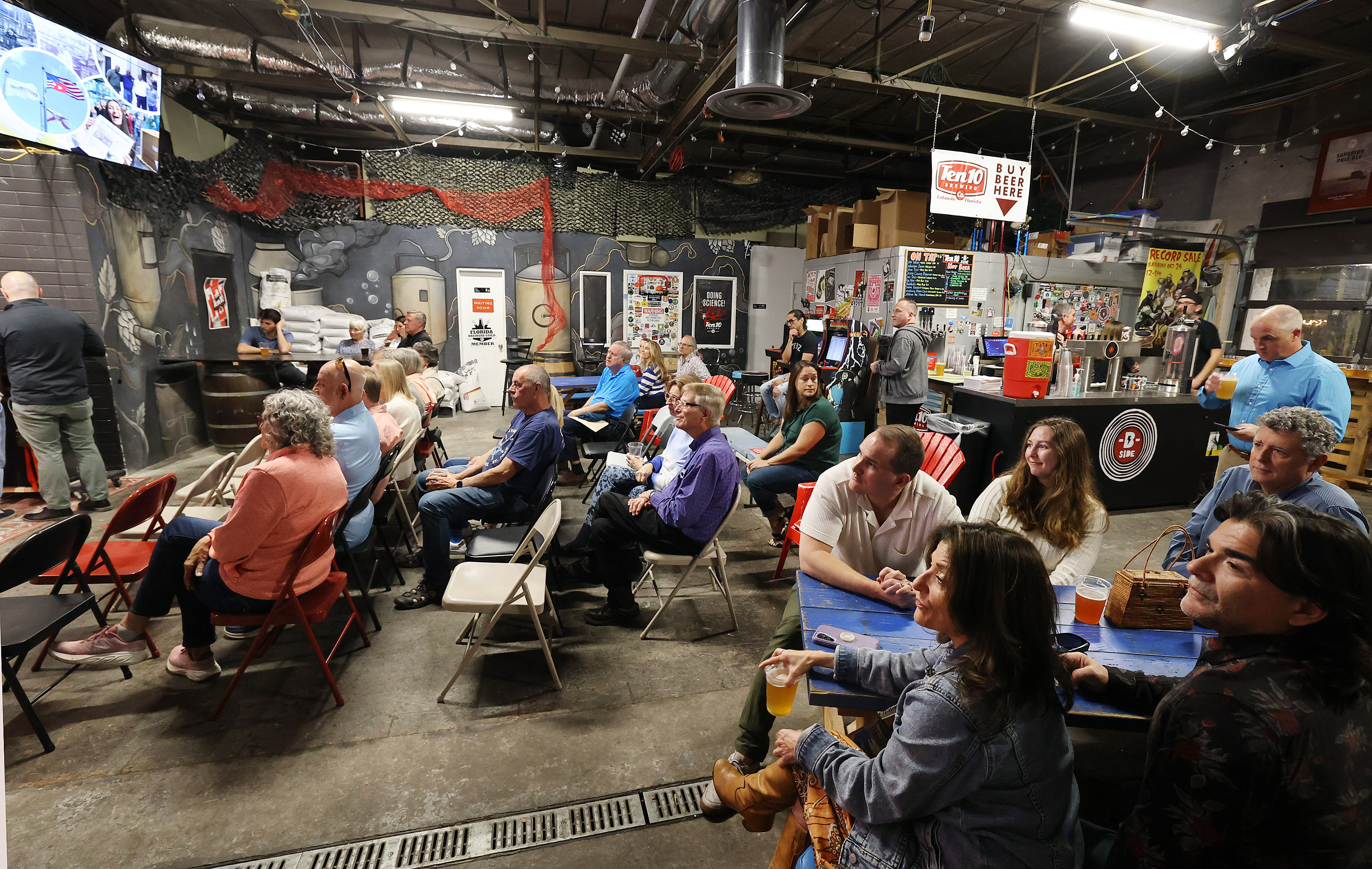 Attendees listen to speakers during a gathering celebrating the Orlando...