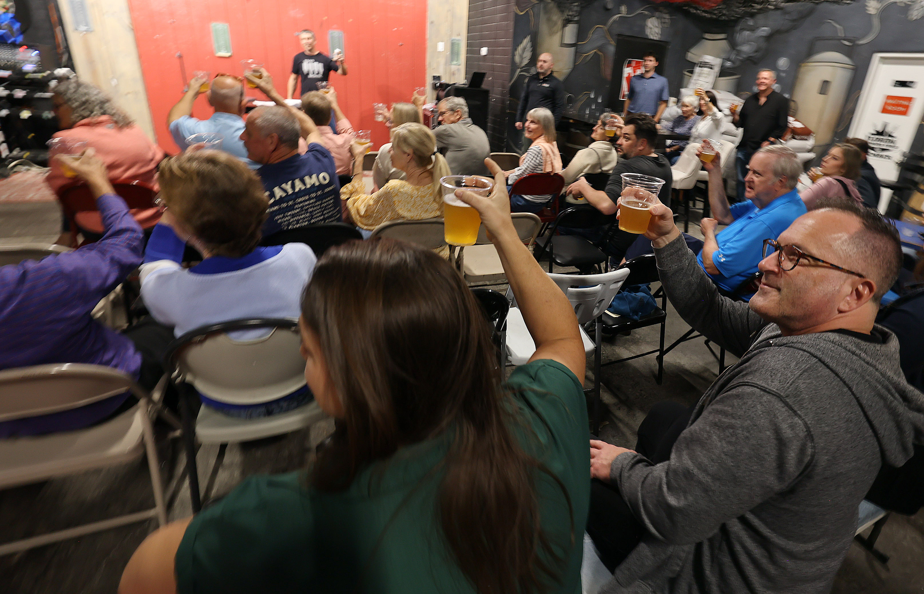 Attendees give a toast during a gathering celebrating the Orlando...