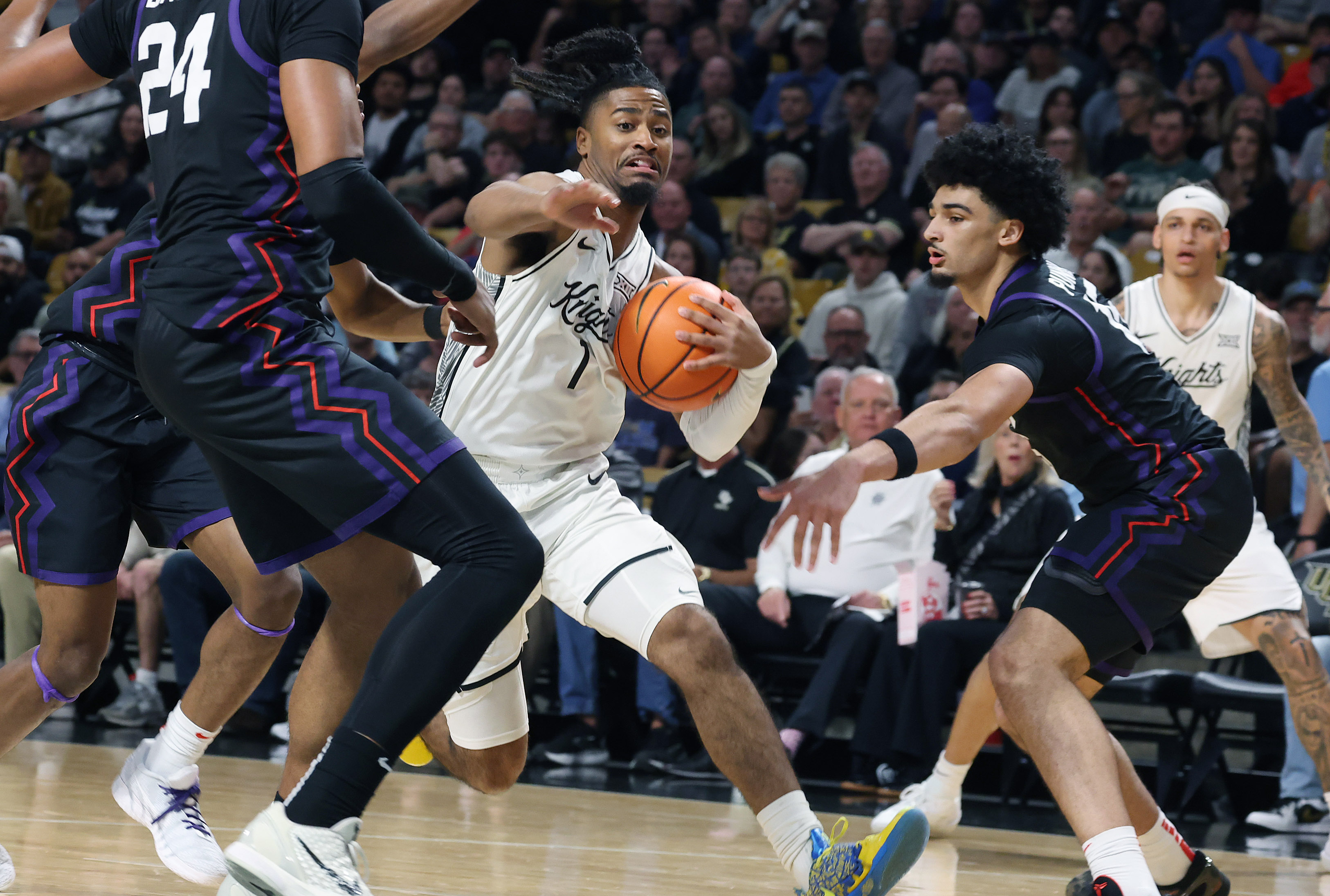 UCF guard Themus Fulks (1) drives through defenders during the...