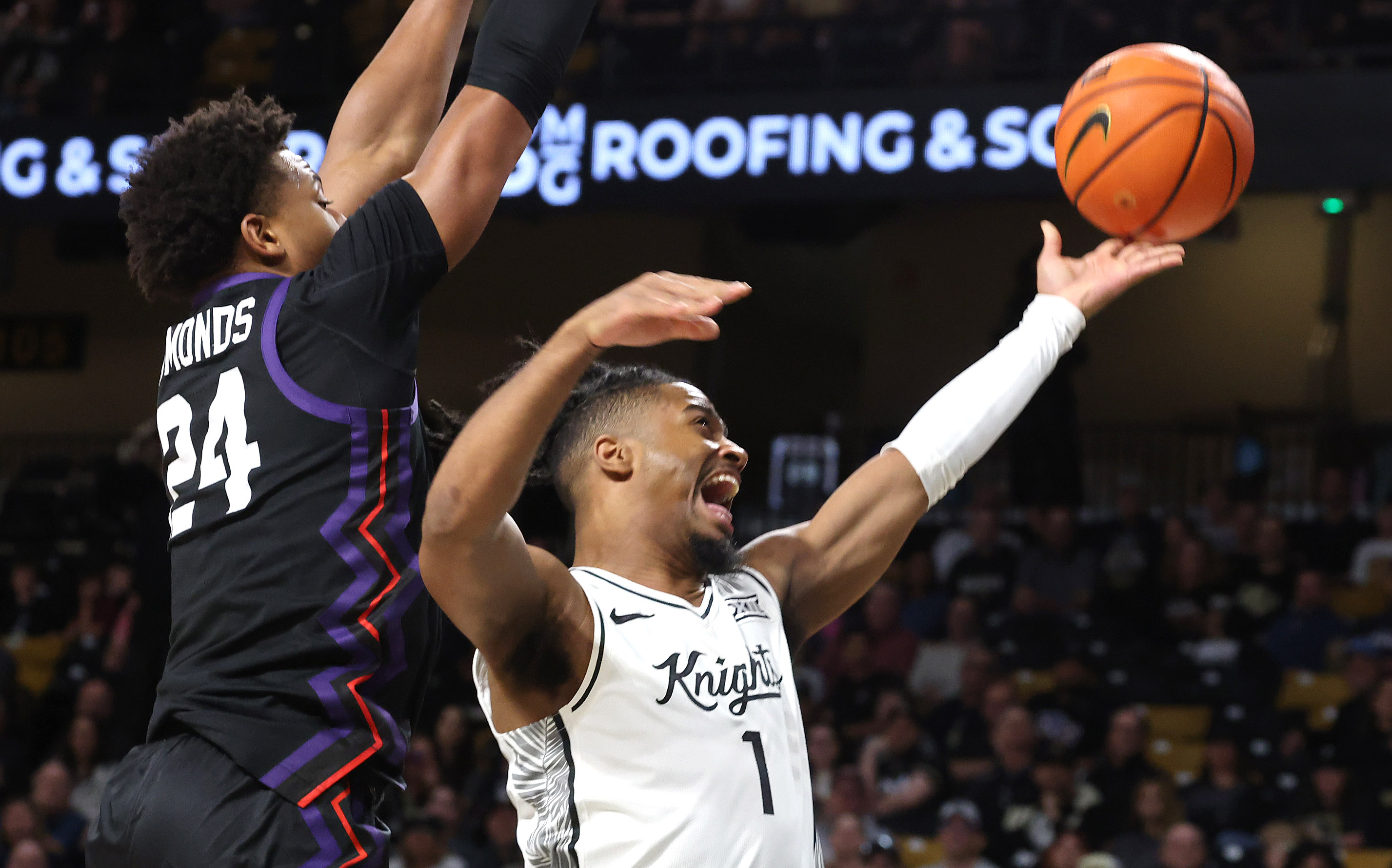 UCF guard Themus Fulks (1) scores past TCU forward Xavier...