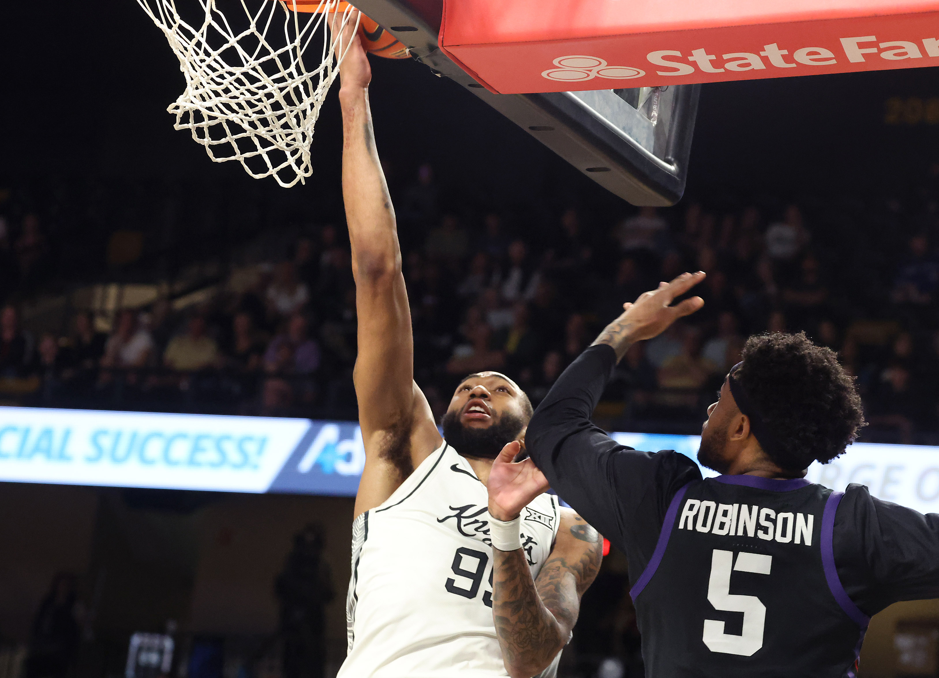 UCF forward Jordan Burks (99) scores beside TCU forward Micah...