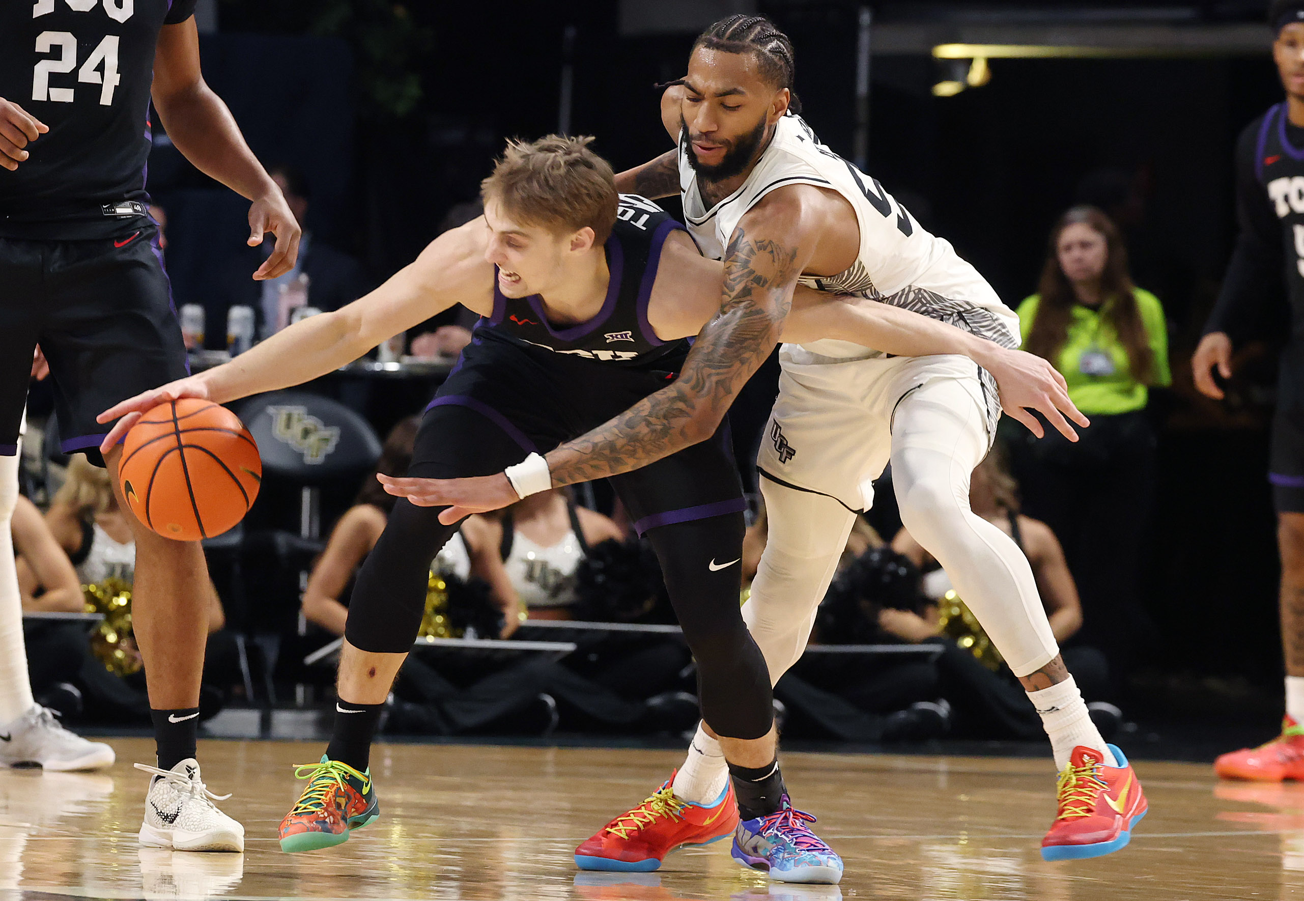 UCF forward Jordon Burks (99) reaches in to knock the...