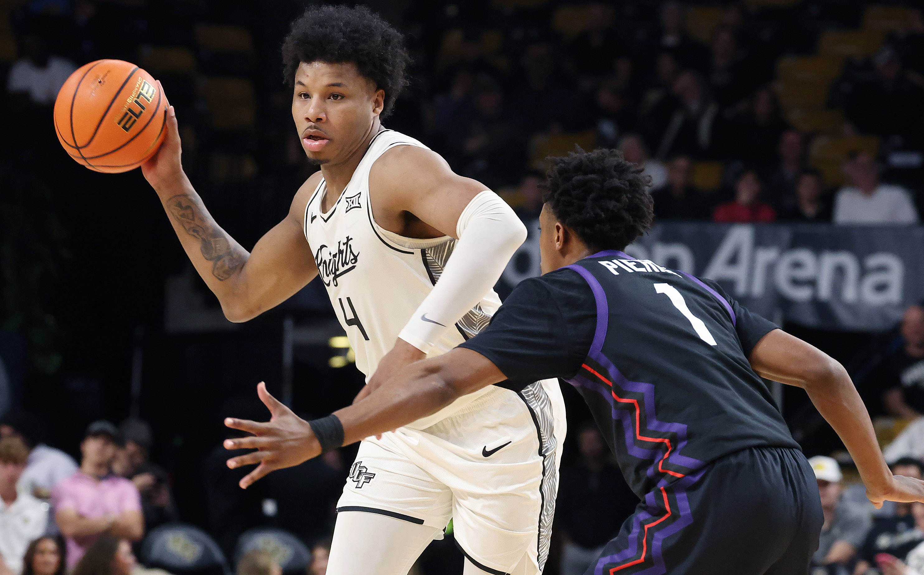 UCF forward Jamichael Stillwell (4) passes around TCU guard Jayden...
