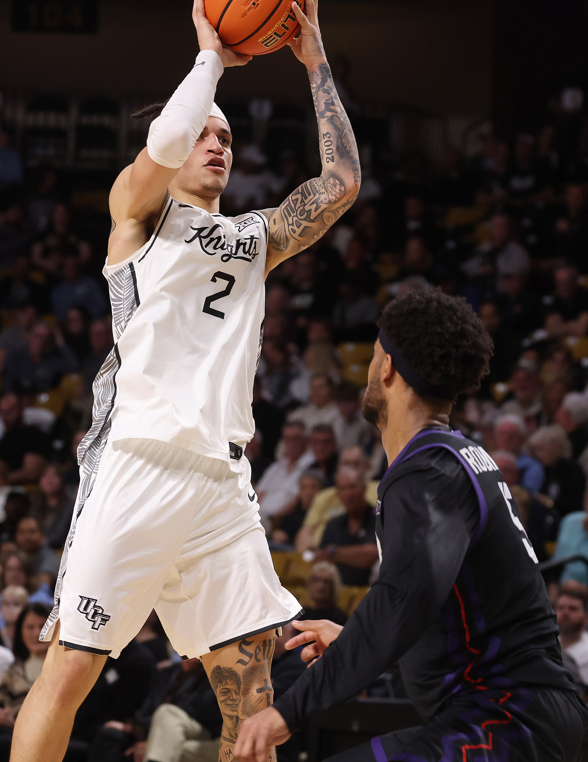 UCF guard Riley Kugel (2) shoots over TCU forward Micah...
