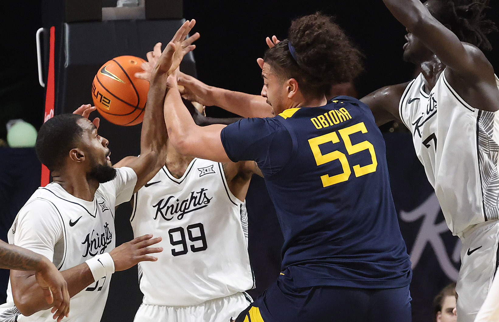 West Virginia center Harian Obioha (55) loses the ball to...