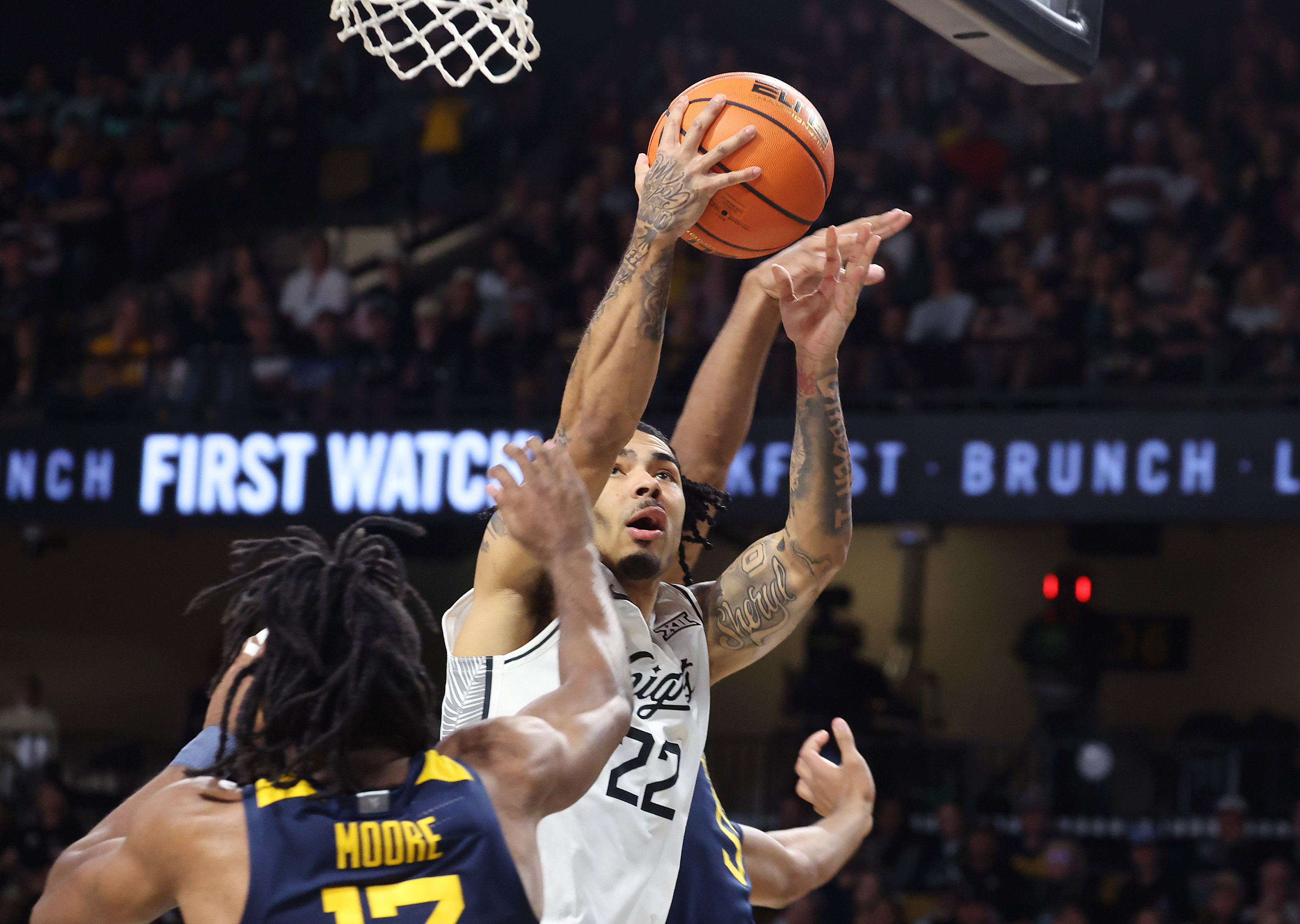 UCF guard Chris Johnson (22) shoots past West Virginia guard...