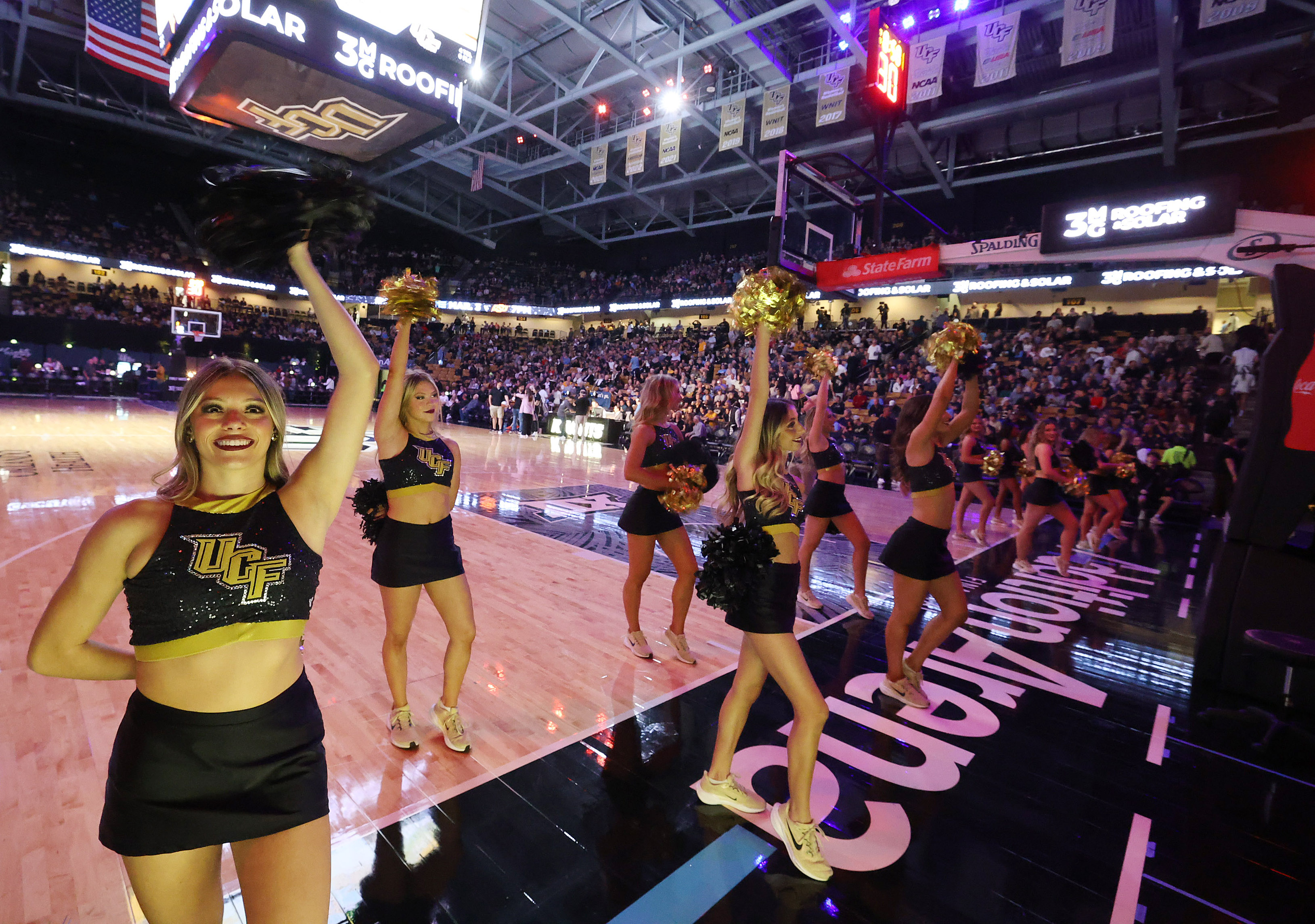 UCF cheerleaders cheer during the West Virginia at UCF college...