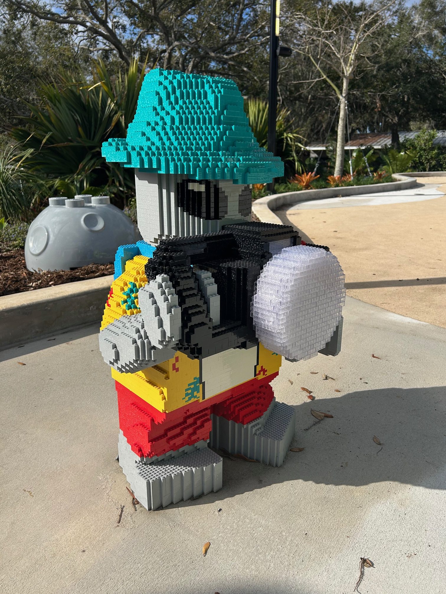 Alien Tourist, an upsided minifigure, stands in the courtyard as...