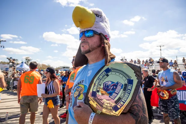 Larry Donnelly of team Hanky Spanky holds his previous champion belt during the Florida Man Games at the Freedom Factory in Bradenton on Feb. 21, 2026. (Patrick Connolly/Orlando Sentinel)