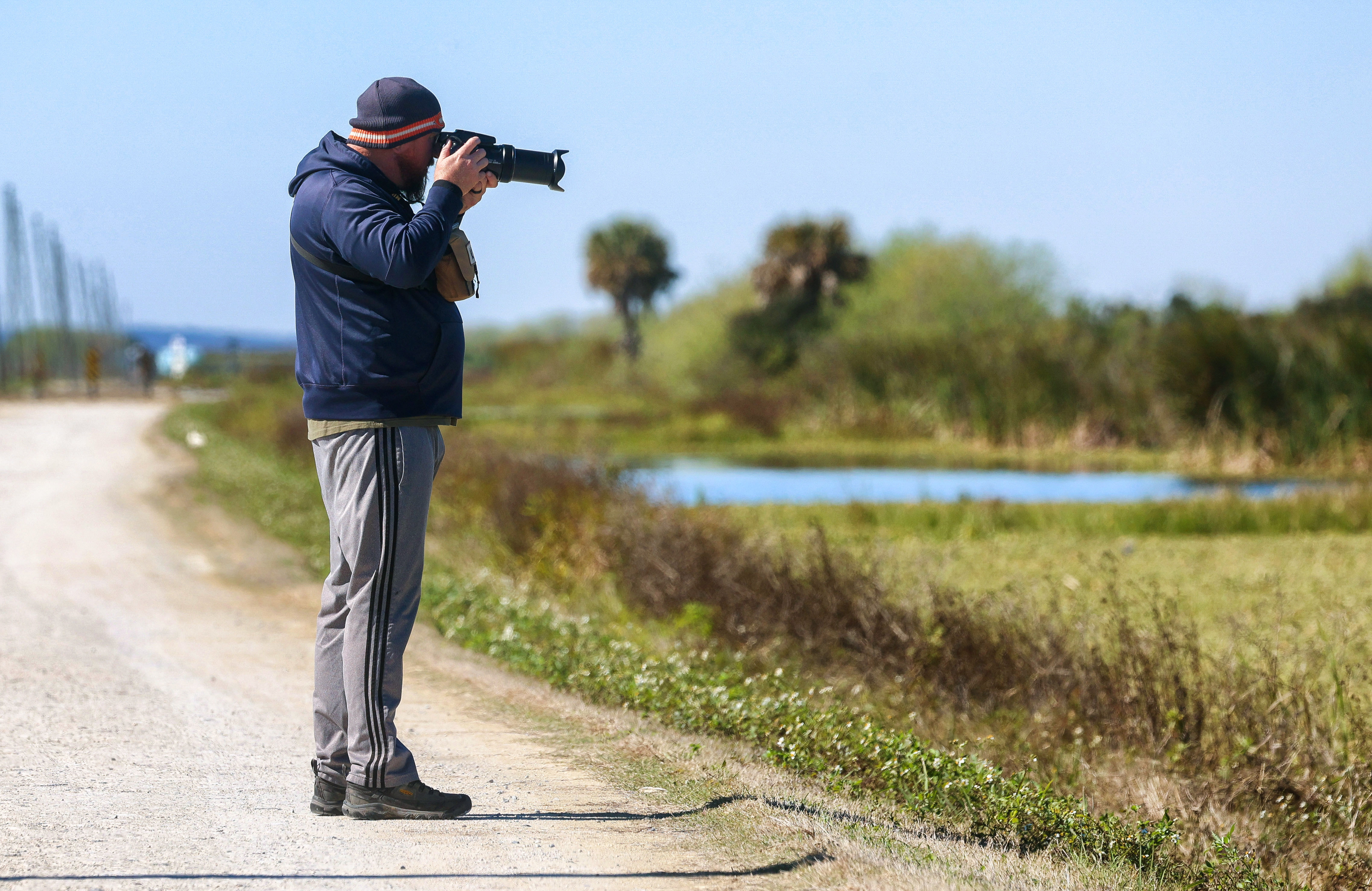 A visitor photographs birds in the wetlands on Lake Apopka...