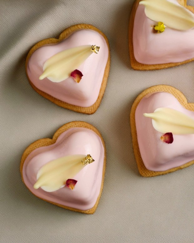 Elegant and edible: The Glass Knife's Strawberry Cheesecake Heart Pastry is finished with a 23-karat gold touched white chocolate feather and dried rose petal. (Photo courtesy The Glass Knife)