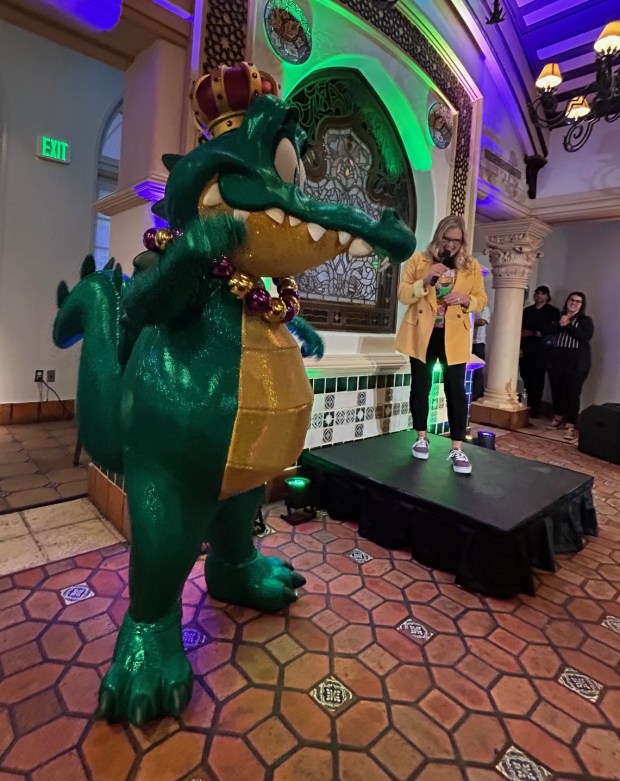 Kelly Malik, show director at Universal Orlando, introduces the Prince Gator character to members of the media at an event on the first night of Universal's Mardi Gras celebration for 2026. Theme park visitors can interact and get photos made with the character. (Dewayne Bevil/Orlando Sentinel)