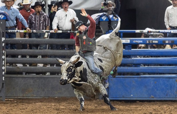 Rooster McKeeman rides the bull for a full eight seconds to score and qualify for the championship round during the 15th Monster Bulls competition at The Silver Spurs Rodeo, in Kissimmee, Saturday, Feb. 15, 2025. The Silver Spurs Rodeo is celebrating their 154th rodeo this week, showcasing the rodeo's seven classic events, including bull riding, bareback riding, saddle bronc riding, barrel racing, team roping, calf roping, and steer wrestling Feb. 20-23. (Willie J. Allen Jr./Orlando Sentinel)