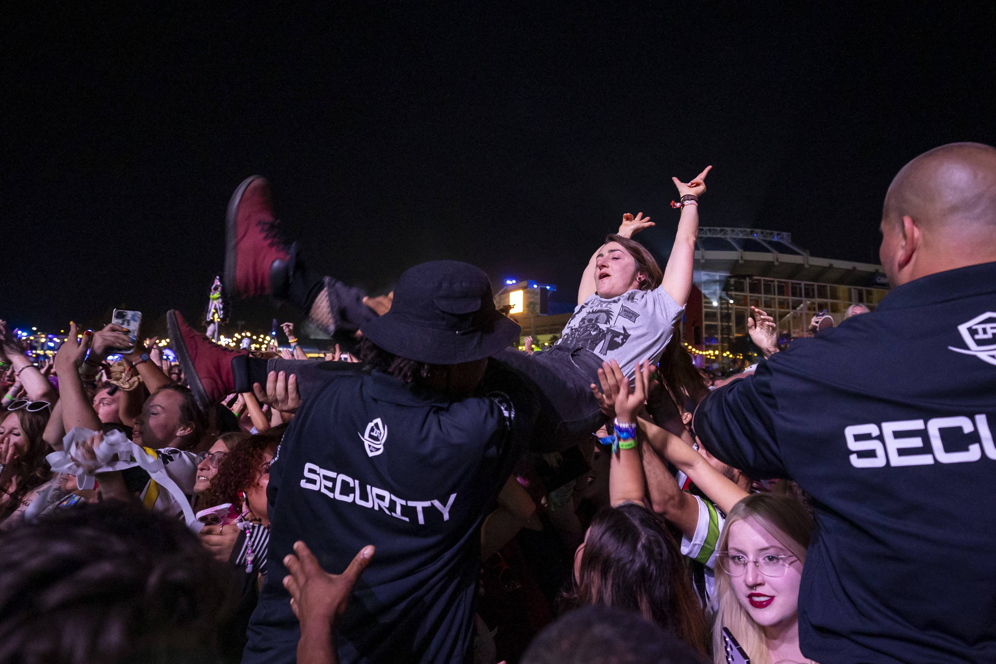 A fan crowdsurfs while All Time Low performs during Vans...
