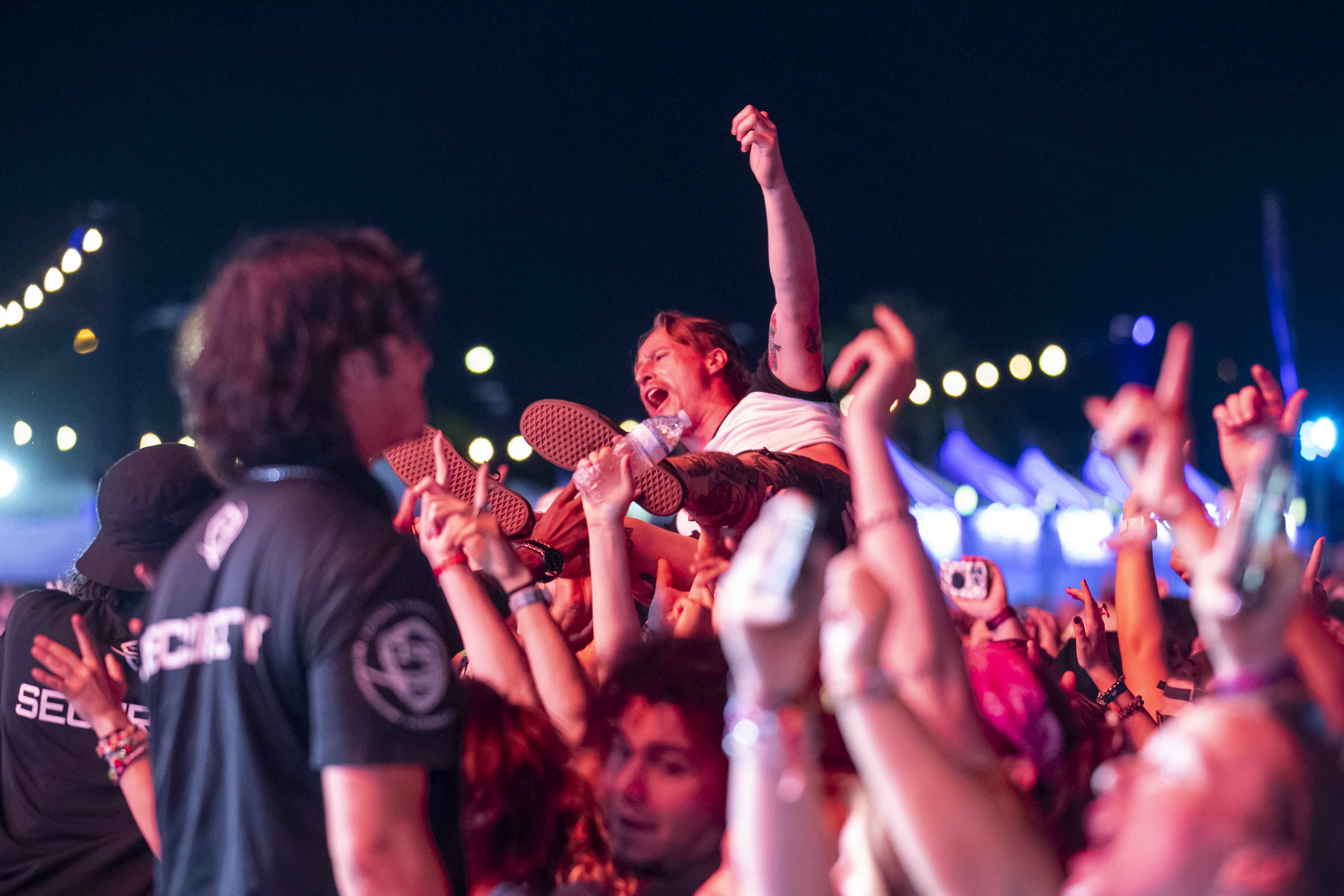 A fan crowdsurfs while All Time Low performs during Vans...
